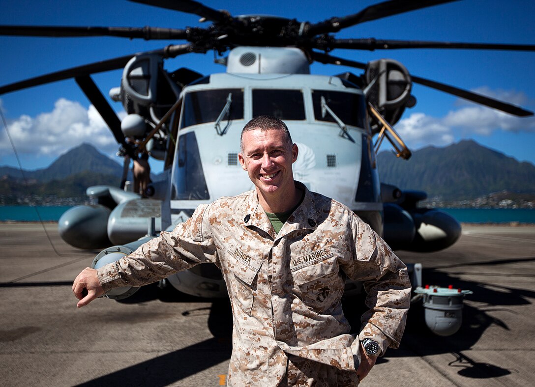U.S. Marine Gunnery Sgt. Frank Dugger, the maintenance control chief for Marine Heavy Helicopter Squadron 463, poses with one of his squadron’s CH-53E Super Stallion helicopters on Marine Corps Air Station Kaneohe Bay, Hawaii, July 25, 2012. The 41-year-old native of Tallahassee, Fla., nearly died from two cardiac episodes while deployed to Afghanistan in 2009. Dugger used his second chance to turn his life around. He quit drinking, began eating more healthily and decided to complete a triathlon. Less than a year later, he completed an Ironman triathlon in Cozumel, Mexico. In total, he’s finished 9 marathons and 30 triathlons.