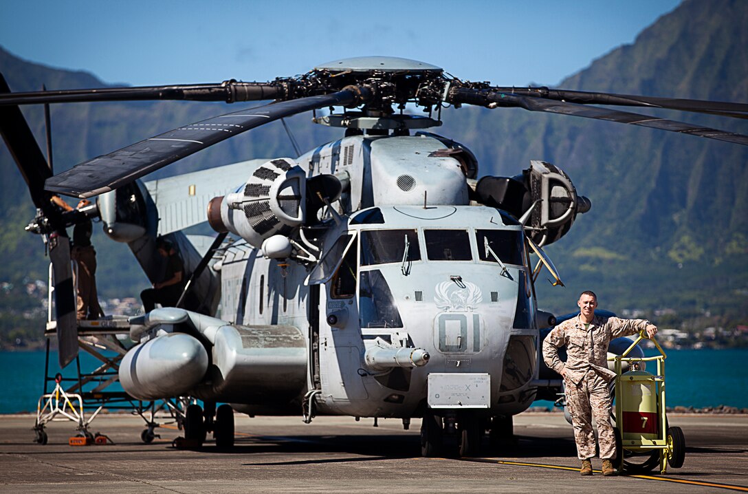 U.S. Marine Gunnery Sgt. Frank Dugger, the maintenance control chief for Marine Heavy Helicopter Squadron 463, poses with one of his squadron’s CH-53E Super Stallion helicopters on Marine Corps Air Station Kaneohe Bay, Hawaii, July 25, 2012. The 41-year-old native of Tallahassee, Fla., nearly died from two cardiac episodes while deployed to Afghanistan in 2009. Dugger used his second chance to turn his life around. He quit drinking, began eating more healthily and decided to complete a triathlon. Less than a year later, he completed an Ironman triathlon in Cozumel, Mexico. In total, he’s finished 9 marathons and 30 triathlons.