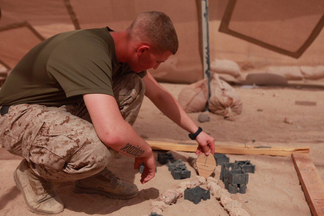 Pfc. Jeffrey Tobash, an Allentown, Pa., native and intelligence specialist with Battalion Landing Team 1st Battalion, 2nd Marine Regiment, 24th Marine Expeditionary Unit, adds a marker to a terrain model aboard Camp Buehring, Kuwait, July 25, 2012. Tobash, just three weeks passed his 19th birthday, is the youngest Marine in the 24th MEU, deployed with the Iwo Jima Amphibious Ready Group as a U.S. Central Command theater reserve force providing support for maritime security operations and theater security cooperation efforts in the U.S. 5th Fleet area of responsibility.