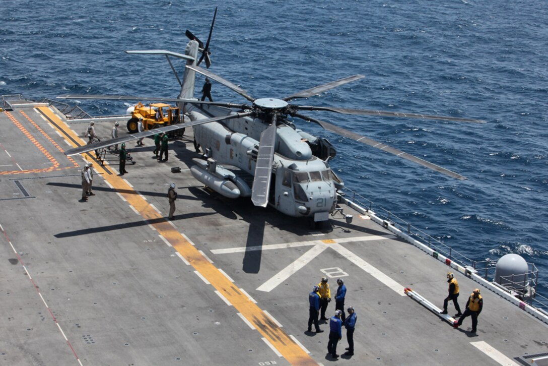 Marines and sailors prepare to stow a CH-53E Super Stallion from Marine Medium Helicopter Squadron 364 (Rein) on the flight deck of the USS Peleliu, July 18, during Composite Unit Training Exercise (COMPTUEX) 2012. The pre-deployment exercise will evaluate the ARGâ€™s ability to conduct integrated military operations and support the 15th Marine Expeditionary Unit as it conducts training operations at sea and ashore in a realistic training environment.
