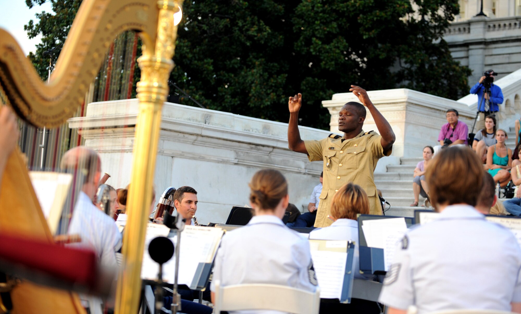 Capt Patrick Odjo, commander of the Music Squadron and Mobile Squadron for the National Gendarmerie in Benin, was a guest conductor for the U.S.Air Force Band as they played for bystanders on the steps of the U.S. Capitol building on July 24,2012 in Washington D.C. The  band hosts this concert every Tuesday from June 5-August 28. (Air Force photo by Senior Airman Christina Brownlow)