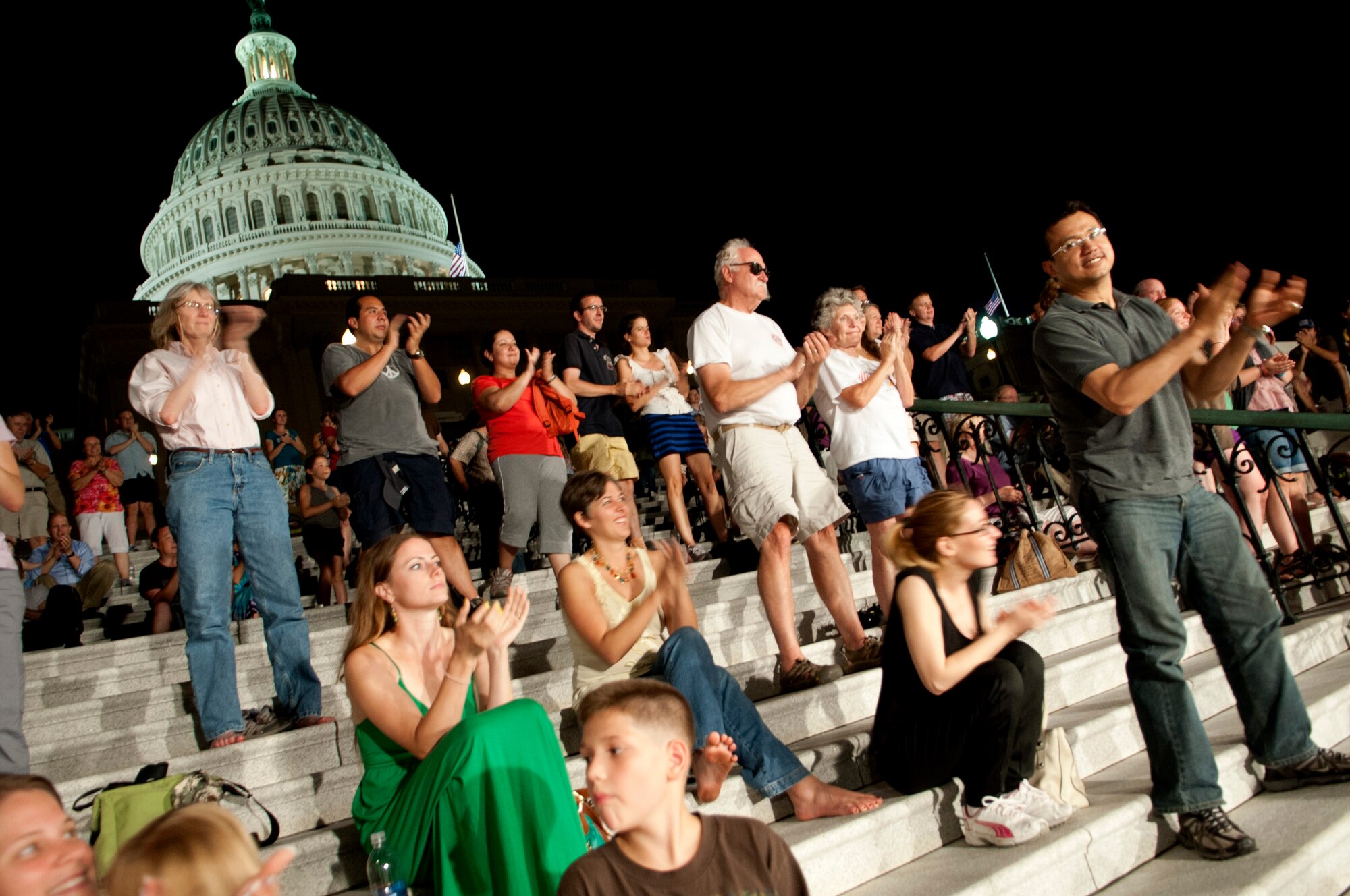 Tourists and patrons clap after hearing opera from the U.S. Air Force band. The band performed on the steps of the U.S. Capitol building on July 24, 2012 in Washington D.C. This concert will be taking place every Tuesday from June 5 to August 28.  The concert hosted Capt. Abiodoun Patrick Odjo, commander of the Music Squadron and Mobile Squadron for the National Gendarmerie Benin Armed Forces, who was a guest conductor.  (U.S. Air Force photo by Master Sgt. Cecilio Ricardo)