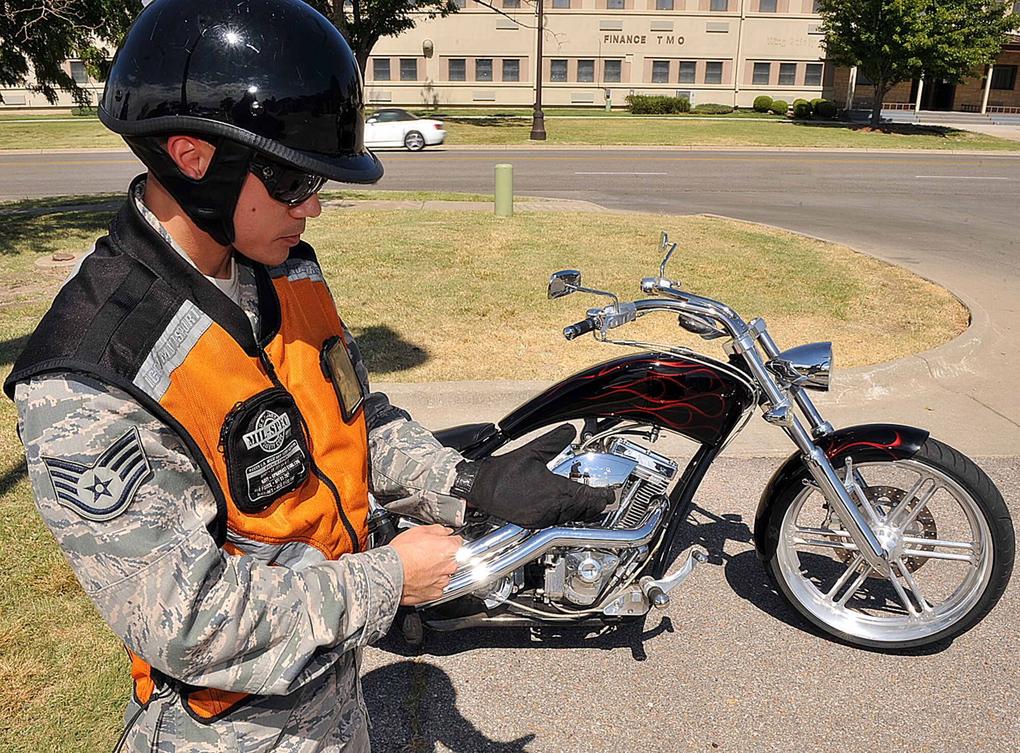 Staff Sgt. Percy Butler, 22nd Communications Squadron network operations NCO in charge, dons his protective gear July 26, 2012, McConnell Air Force Base, Kan. Airmen riders must be properly trained, licensed and wear protective gear at all times to reduce potential motorcycle incidents. (U.S. Air Force photo/Airman 1st Class Maurice A. Hodges)