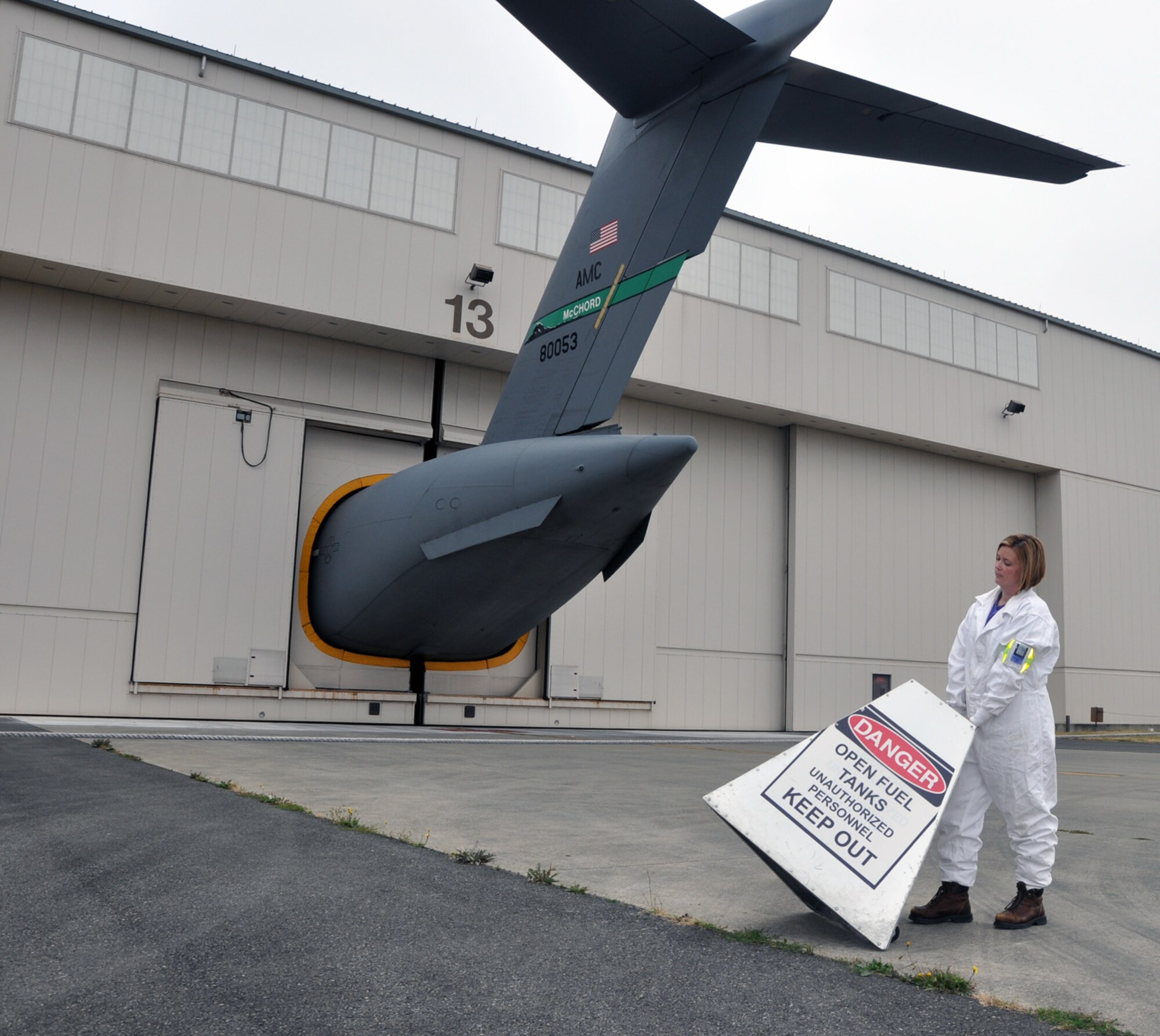 MCCHORD FIELD, Wash. – Tech. Sgt. Deidre Barry, 446th Maintenance Squadron aircraft fuels systems technician, cordons off a safety area outside Hangar 13 here, July 26.  Work performed by aircraft fuels systems technicians requires strict safety procedures for personnel and equipment.  (Photo illustration by Tech. Sgt. Elizabeth Moody)