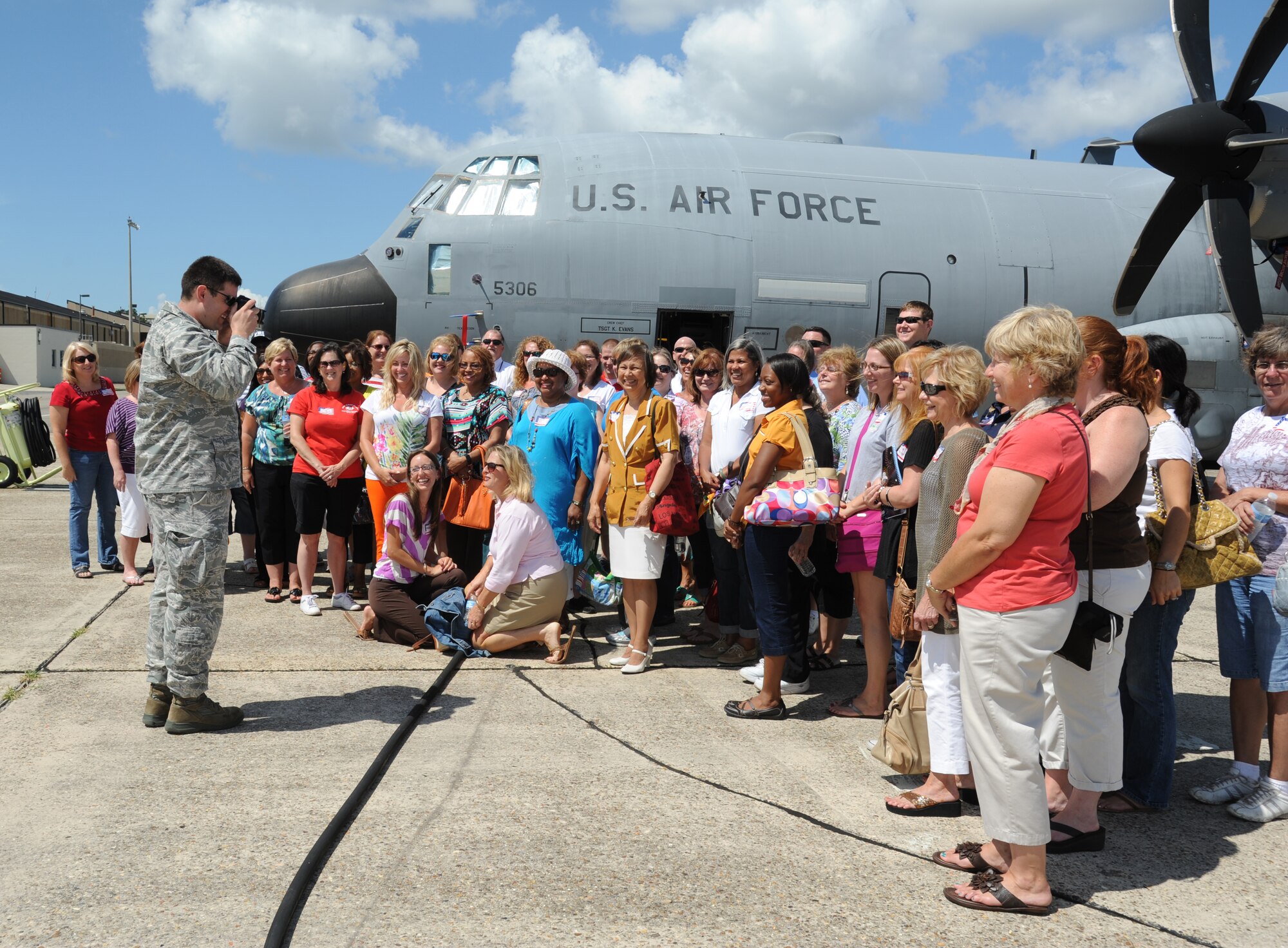 Capt. J. Justin Pearce, 403rd Wing, takes a group photo during a tour for educators from local schools along the Gulf Coast July 26, 2012, at Keesler Air Force Base, Miss. They also toured the 335th Training Squadron weather school, received a briefing by the 403rd Wing on their job duties and ate lunch at the Sablich Center.  (U.S. Air Force photo by Kemberly Groue)