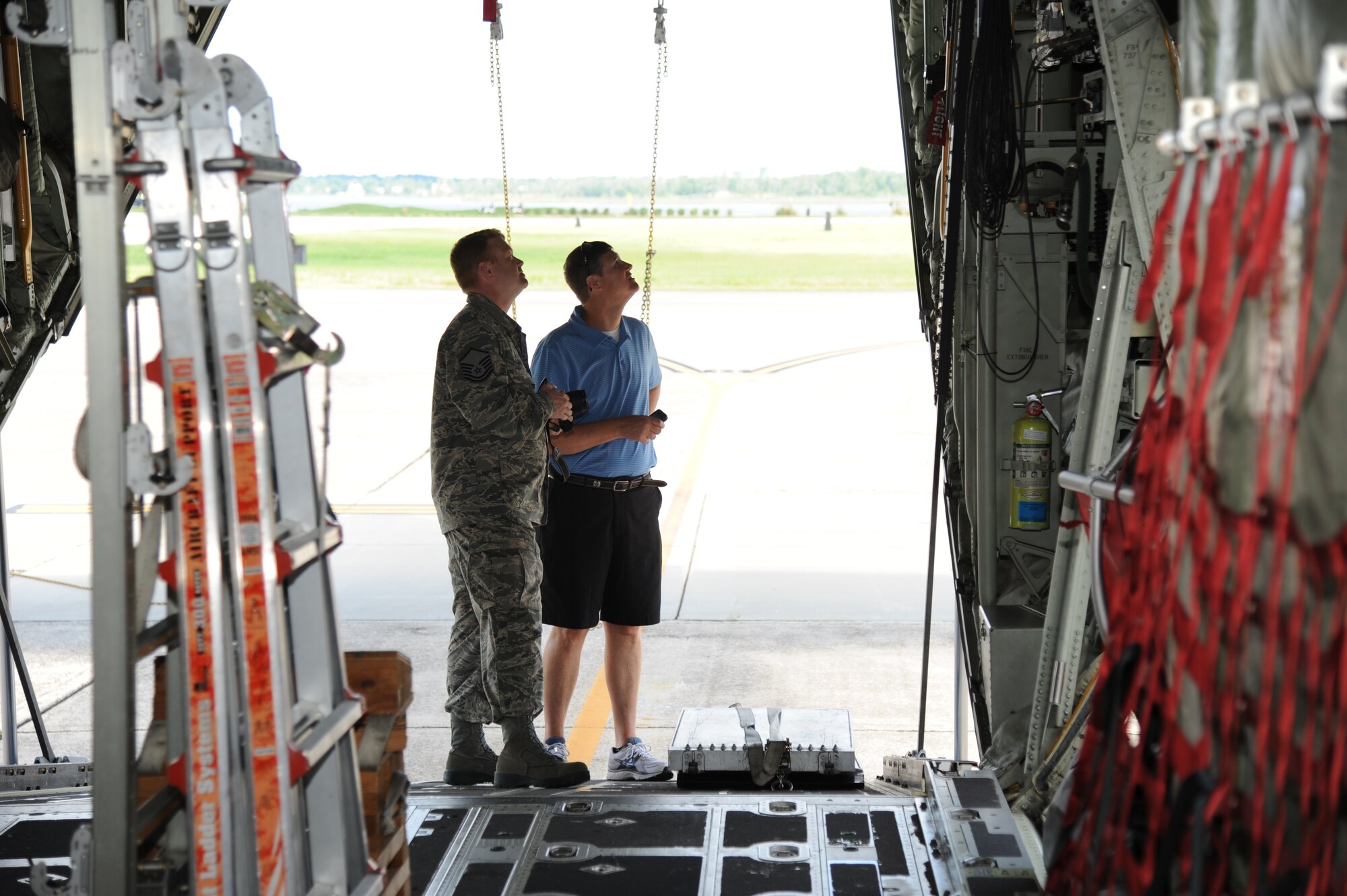 Master Sgt. Brian Lamar, 403rd Wing, answers questions about a C-130J Hercules aircraft for Jon Miles, Bayou View Middle School teacher in Gulfport, Miss., during a tour for educators from local schools along the Gulf Coast during an educator tour July 26, 2012, at Keesler Air Force Base, Miss. They also toured the 335th Training Squadron weather school, received a briefing by the 403rd Wing on their job duties and ate lunch at the Sablich Center.  (U.S. Air Force photo by Kemberly Groue)
