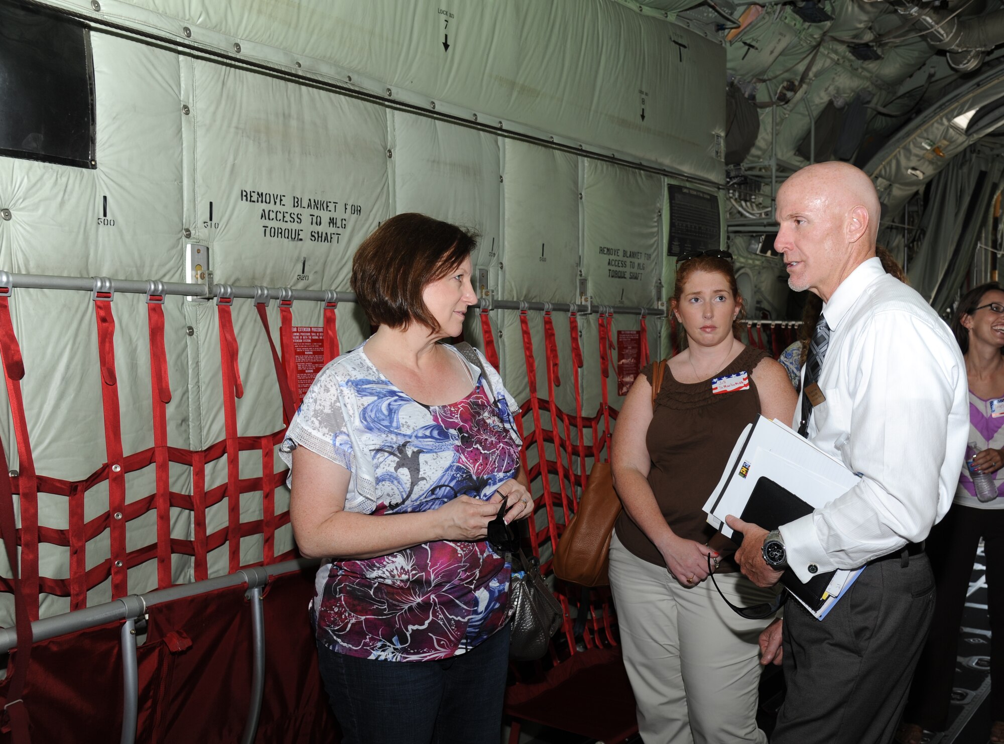 Carmen Sheets and Jill Holcomb, St. Martin Middle School teachers in Jackson County, receive a tour of a C-130J Hercules aircraft by Gerald Cross, 81st Force Support Squadron school liaison officer, during a tour for educators from local schools along the Gulf Coast July 26, 2012, at Keesler Air Force Base, Miss. They also toured the 335th Training Squadron weather school, received a briefing by the 403rd Wing on their job duties and ate lunch at the Sablich Center.  (U.S. Air Force photo by Kemberly Groue)