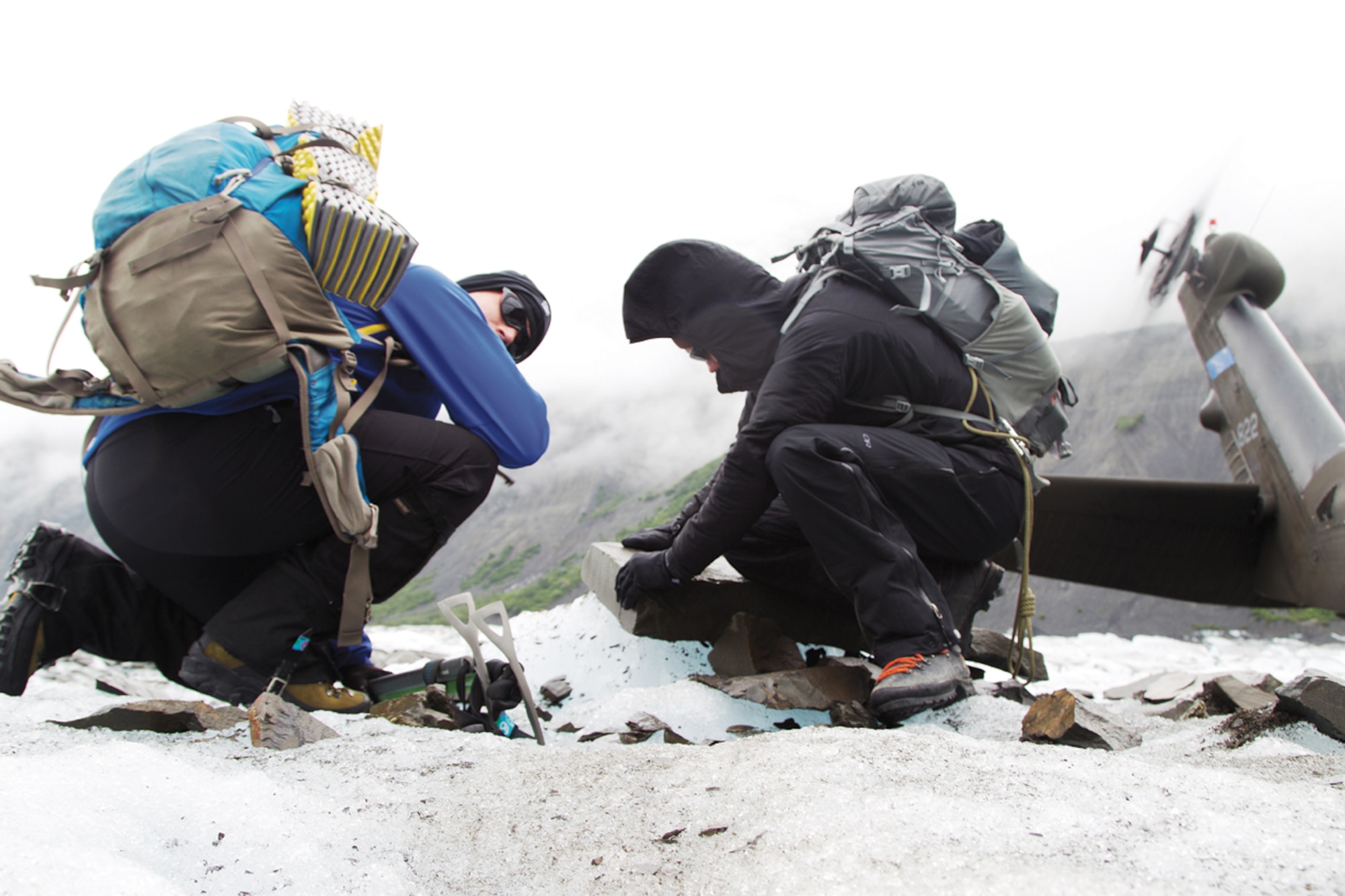 Army Capt. Daniel Perpich and Staff Sgt. Joshua Richardson, of US Army Northern Warfare Training Center, search Colony Glacier for debris July 10, 2012. The Joint Base Elmendorf-Richardson recovery team responded to a sighting by the Alaska Army National Guard that appeared to be an aircraft wreckage. (US Army photo/Staff Sgt. Brehl Garza)