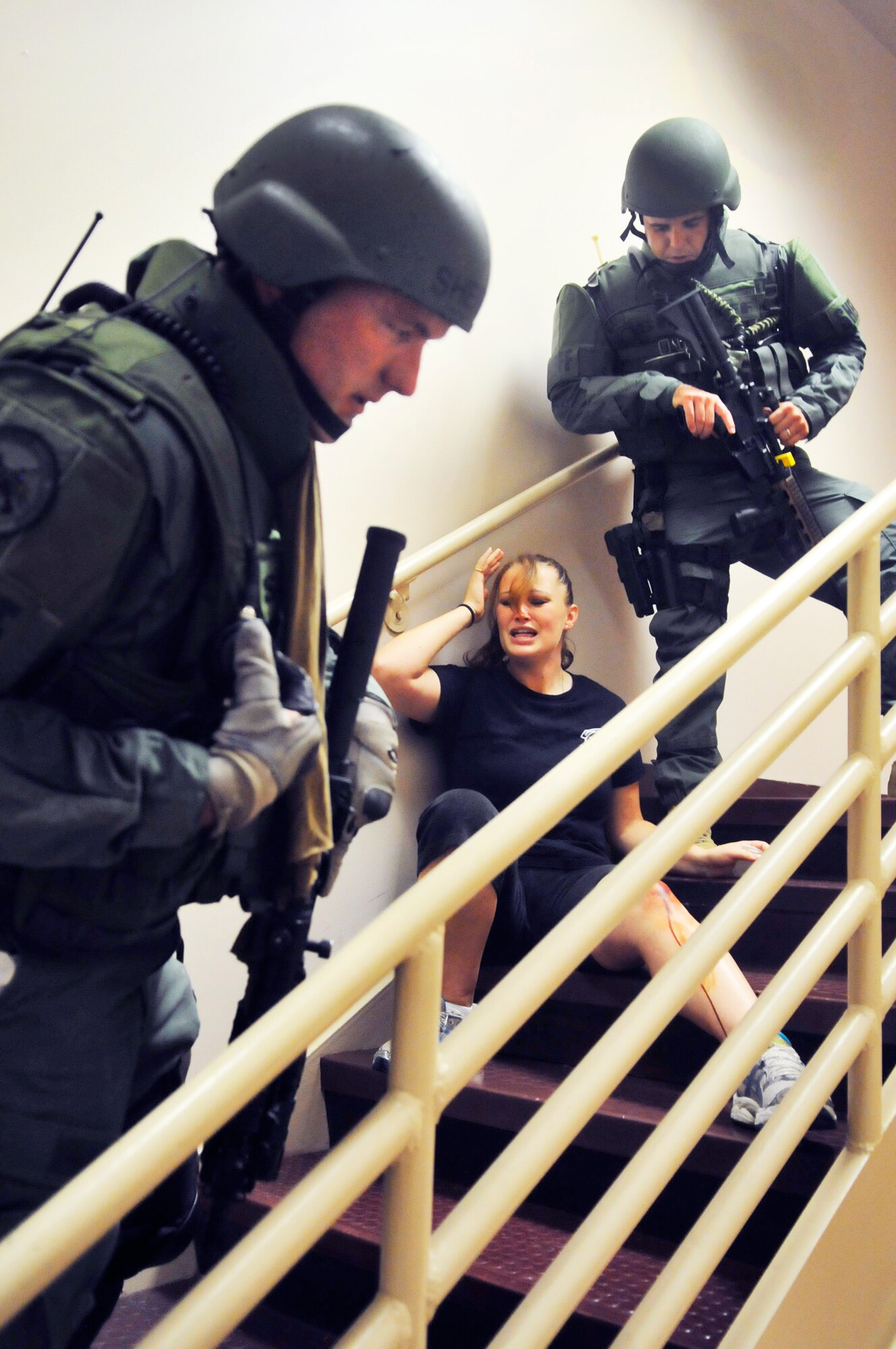 Houston County Sheriff Department personnel encounter a victim in a stairwell during a simulated active shooter exercise at Robins Thursday. (U. S. Air Force photo/Sue Sapp)
