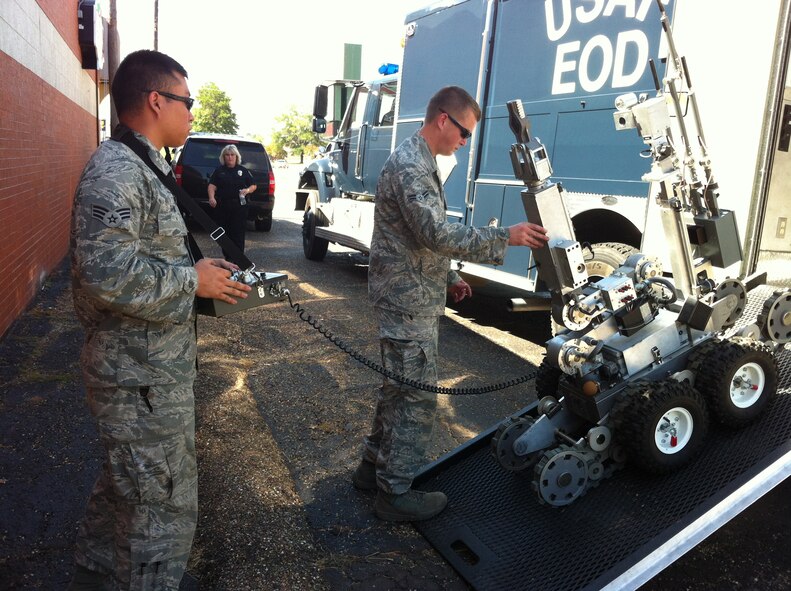 Senior Airman Alex Gaunt and Airman 1st Class T.J. Brantley, 2nd Civil Engineer Squadron Explosive Ordinance Disposal flight technicians, steer a robot into the EOD truck following an incident in Longview, Texas, July 25. A suspicious device inside of a newspaper stand drew the concern of local law enforcement, who requested Barksdale EOD respond to the scene. After a careful inspection process involving a robot and an EOD technician in a bomb suit, the device was found to be harmless. (U.S. Air Force photo/1st Lt. Victoria Lalich)(RELEASED)