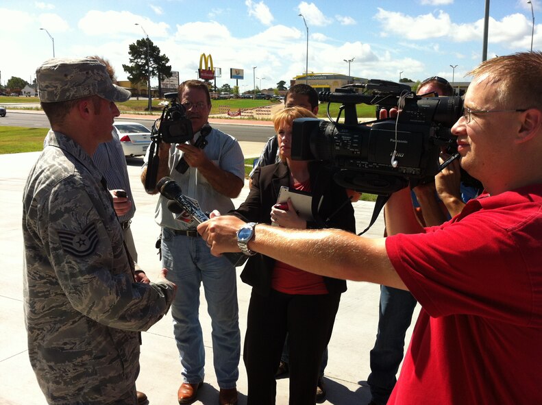 Tech. Sgt. Bart Matthews, 2nd Civil Engineer Squadron Explosive Ordinance Disposal flight technician, is interviewed by local media following an incident outside of a restaurant in Longview, Texas, July 25. A suspicious device inside of a newspaper stand drew the concern of local law enforcement, who requested Barksdale EOD respond to the scene. After a careful inspection process involving a robot and an EOD technician in a bomb suit, the device was found to be harmless. (U.S. Air Force photo/1st Lt. Victoria Lalich)(RELEASED)