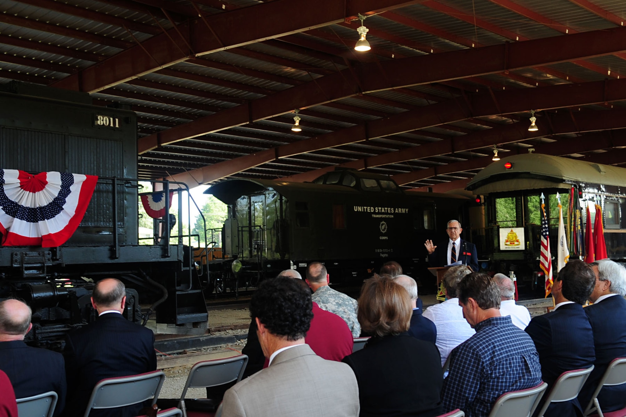 Retired Army Col. James Rockey, U.S. Army Transportation Museum Foundation president, addresses the crowd during the Transportation Corps’ 70th Anniversary Ceremony at Fort Eustis, Va., July 24, 2012. The foundation plans to add a 1940s-era rail station mock-up inside the pavilion, allowing visitors to tour the interior of the train cars and locomotives from station platforms. (U.S. Air Force photo by Staff Sgt. Ashley Hawkins/Released)