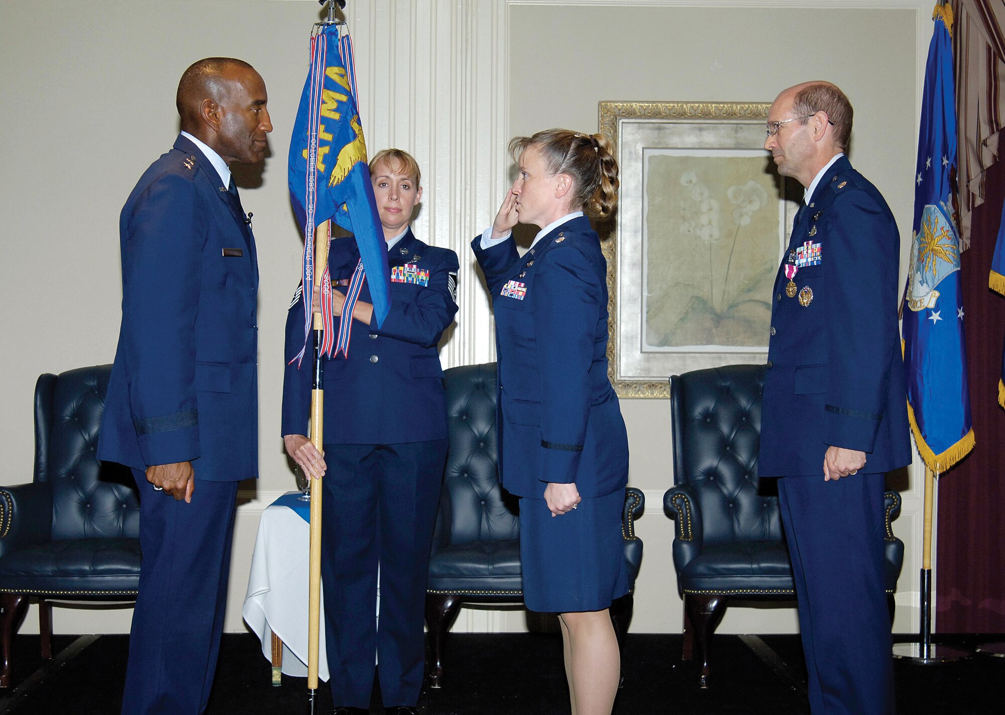 Lt. Col. Tracy Hunter, center, 5th Manpower Requirements Squadron's new commander, salutes AFPC commander, Maj. Gen. A.J. Stewart, left, during a change command ceremony at Tinker AFB, Okla., July 19.  