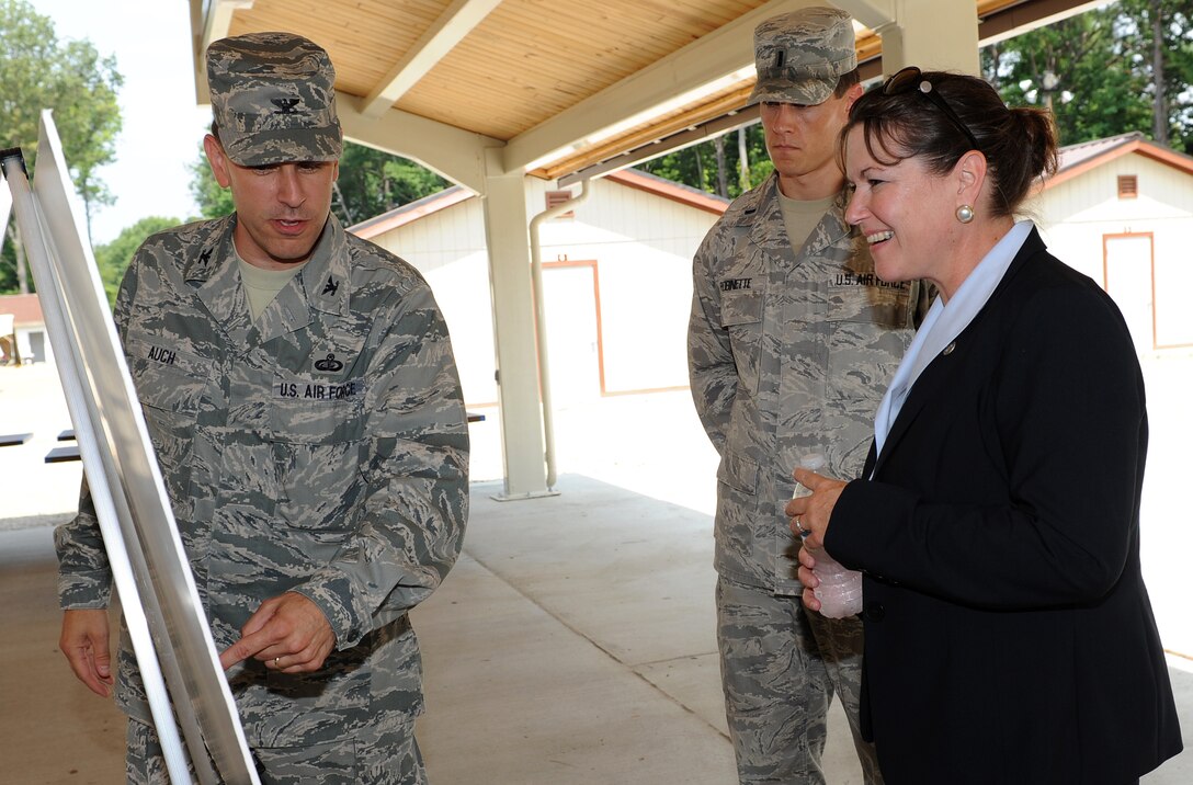 U.S. Air Force Col. Korvin Auch, left, 633rd Air Base Wing commander, and 1st Lt. Eric Robinette, 633rd Civil Engineer Squadron SABER officer in charge, brief Terri Suit, Virginia Secretary of Veterans Affairs and Homeland Security, about recent construction projects to Raptor Town, at Langley Air Force Base, Va., July 26, 2012. Suit toured various areas of the base and assessed the facilities and security measures. (U.S. Air Force photo by Airman 1st Class Teresa Cleveland/Released)