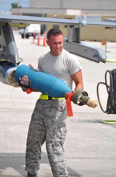 Senior Airman Anthony Alvarez, 482nd Aircraft Maintenance Squadron, mounts the head of a GBU-54 bomb during the 482nd Aircraft Maintenance Squadron’s quarterly Load Crew Competition at Homestead Air Reserve Base, July 15. The GBU-54 bomb is guided by a GPS configured with semi-active laser seeker.