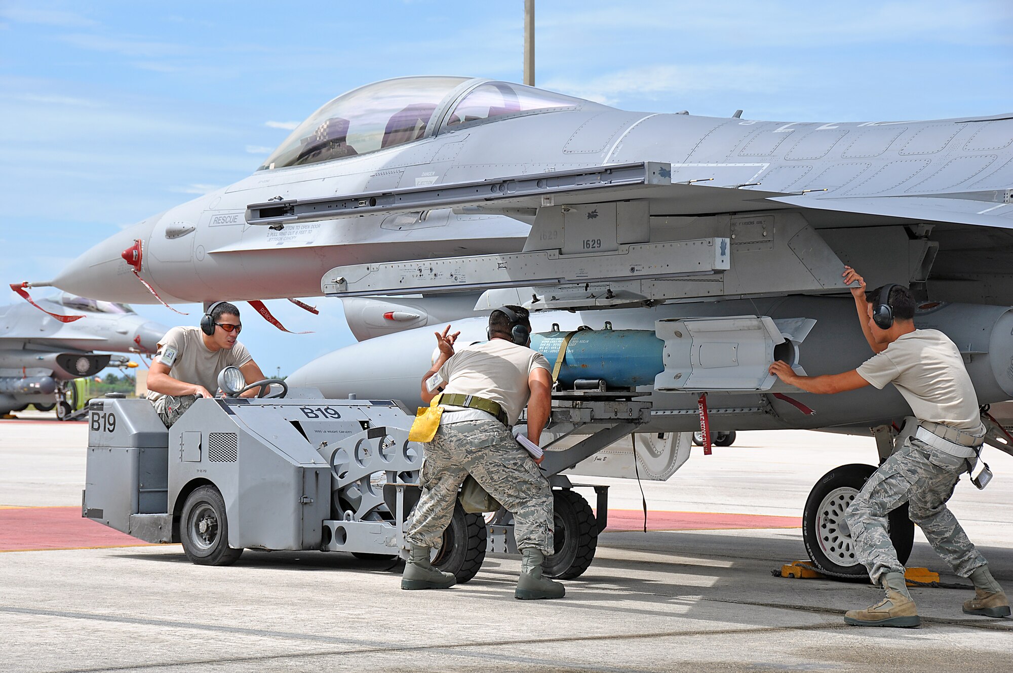 Senior Airman Antonio Ortega (left), Master Sgt. Nelson Rodriguez (center), and Senior Airman Christian Marrero-Santana (right), load a GBU-54 bomb onto an F-16 during the 482nd Aircraft Maintenance Squadron’s quarterly Load Crew Competition at Homestead Air Reserve Base, July 15. The winning load crews for each quarter will compete against each other at the end of the year for Homestead Air Reserve Base’s Best Load Crew of the Year title.