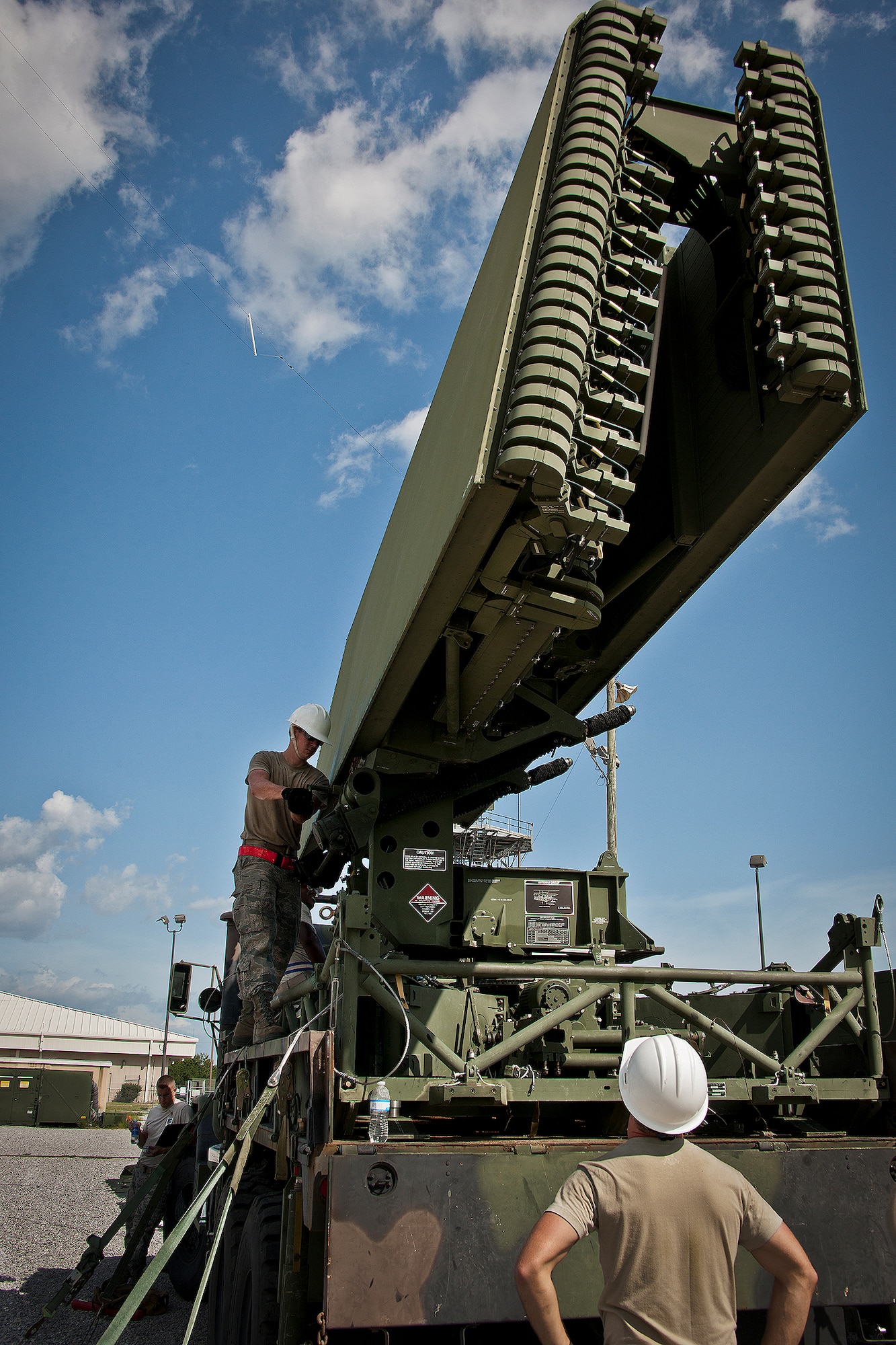 Airman 1st Class Daniel Hilliard hand cranks the deployment of a TPS-75 radar set antenna in support a 728th Air Control Squadron deployment readiness exercise called Bison Fury July 24, 2012, at Eglin Air Force Base, Fla. This exercise marks the last large-scale exercise for the squadron, which is scheduled to be deactivated in 2013. (U.S. Air Force photo/Samuel King Jr.)



