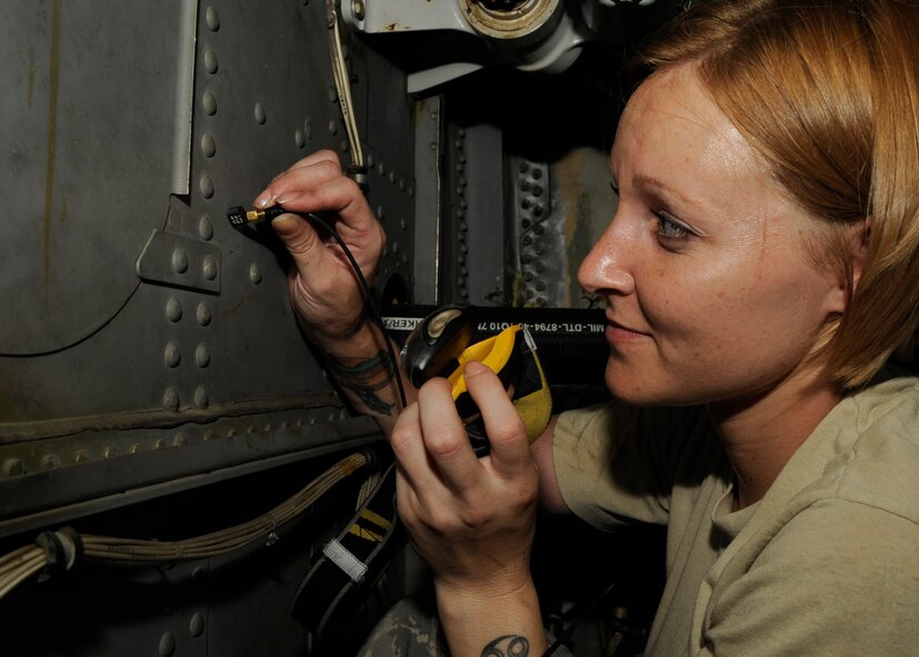Senior Airman Jessica Cassiday, 2nd Maintenance Squadron non-destructive inspection journeyman, uses a USN60 ultrasonic unit to test metal inside a B-52H Stratofortress on Barksdale Air Force Base, La., July 25. Cassiday performed an inspection using the USN60 to detect cracks on the 694 bulkhead located in a crawl space above the bomb bay of a B-52H. (U.S. Air Force photo/Airman 1st Class Joseph A. Pagán Jr.)(RELEASED)