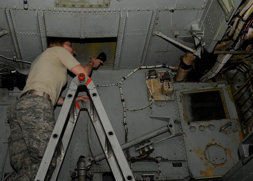 Senior Airman Jessica Cassiday, 2nd Maintenance Squadron non-destructive inspection journeyman, inspects the 694 bulkhead, located inside a crawl space of a B-52H Stratofortress on Barksdale Air Force Base, La., July 25. Cassiday performed an inspection using a USN60 ultrasonic unit to detect any cracks on the 694 bulkhead. (U.S. Air Force photo/Airman 1st Class Joseph A. Pagán Jr.)(RELEASED)