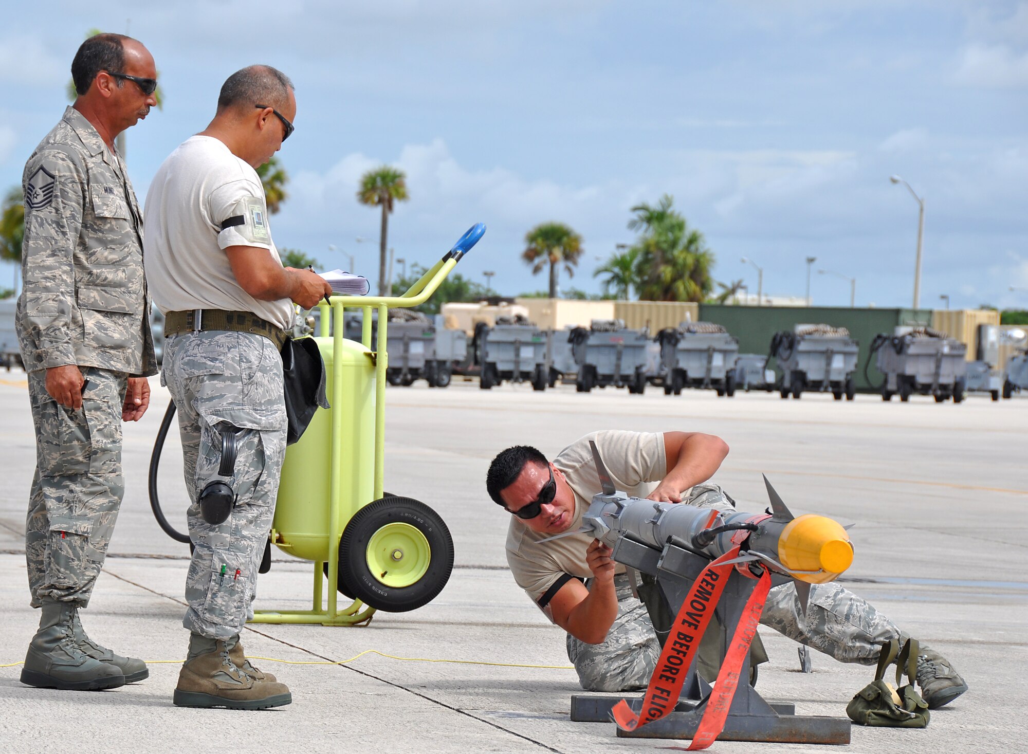Technical Sgt. Carlos Arias and Senior Airman Jose Contreras, 482nd Aircraft Maintenance Squadron, prepares an AIM-9X missile to be loaded onto an F-16 while under the eye of evaluator Master Sgt. Roberto Muniz, 482nd Aircraft Maintenance Squadron, during the 482nd Aircraft Maintenance Squadron’s quarterly Load Crew Competition at Homestead Air Reserve Base, July 15. The load crews were evaluated in four areas to determine the winner: dress and personal appearance, toolkit inspection, a general knowledge test, and actual munitions loading to include speed and proficiency.