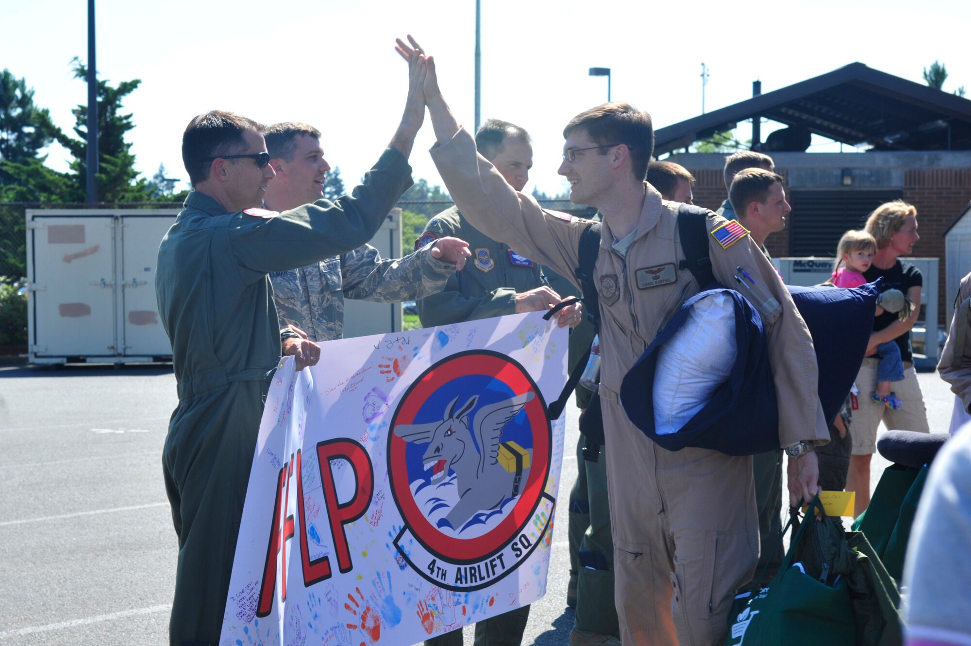 Lt. Col. Ira Cline, 62nd Airlift Wing Rodeo director, wishes Airmen good luck as they depart for a 60-day deployment July 25, 2012, at Joint Base Lewis-McChord, Wash. The 4th AS deployed in support of Operations Enduring Freedom, New Dawn, Odyssey Dawn and Combined Joint Task Force-Horn of Africa. (U.S. Air Force photo/Staff Sgt. Frances Kriss)
