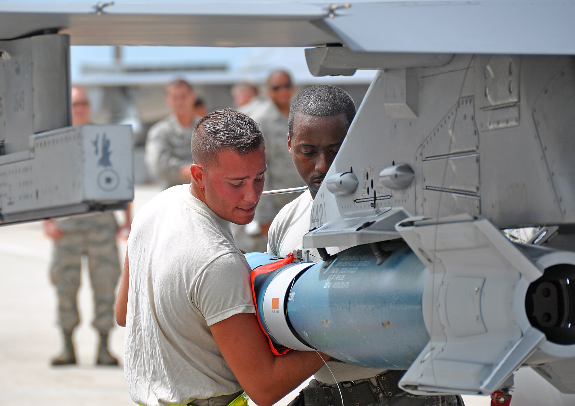 Senior Airman Anthony Alvarez (left) and Master Sgt. Clinton Noland (right) of the 482nd Aircraft Maintenance Squadron, mount the head of a GBU-54 bomb during the 482nd Aircraft Maintenance Squadron’s quarterly Load Crew Competition at Homestead Air Reserve Base, July 15. The GBU-54 bomb is guided by a GPS configured with a laser seeker.