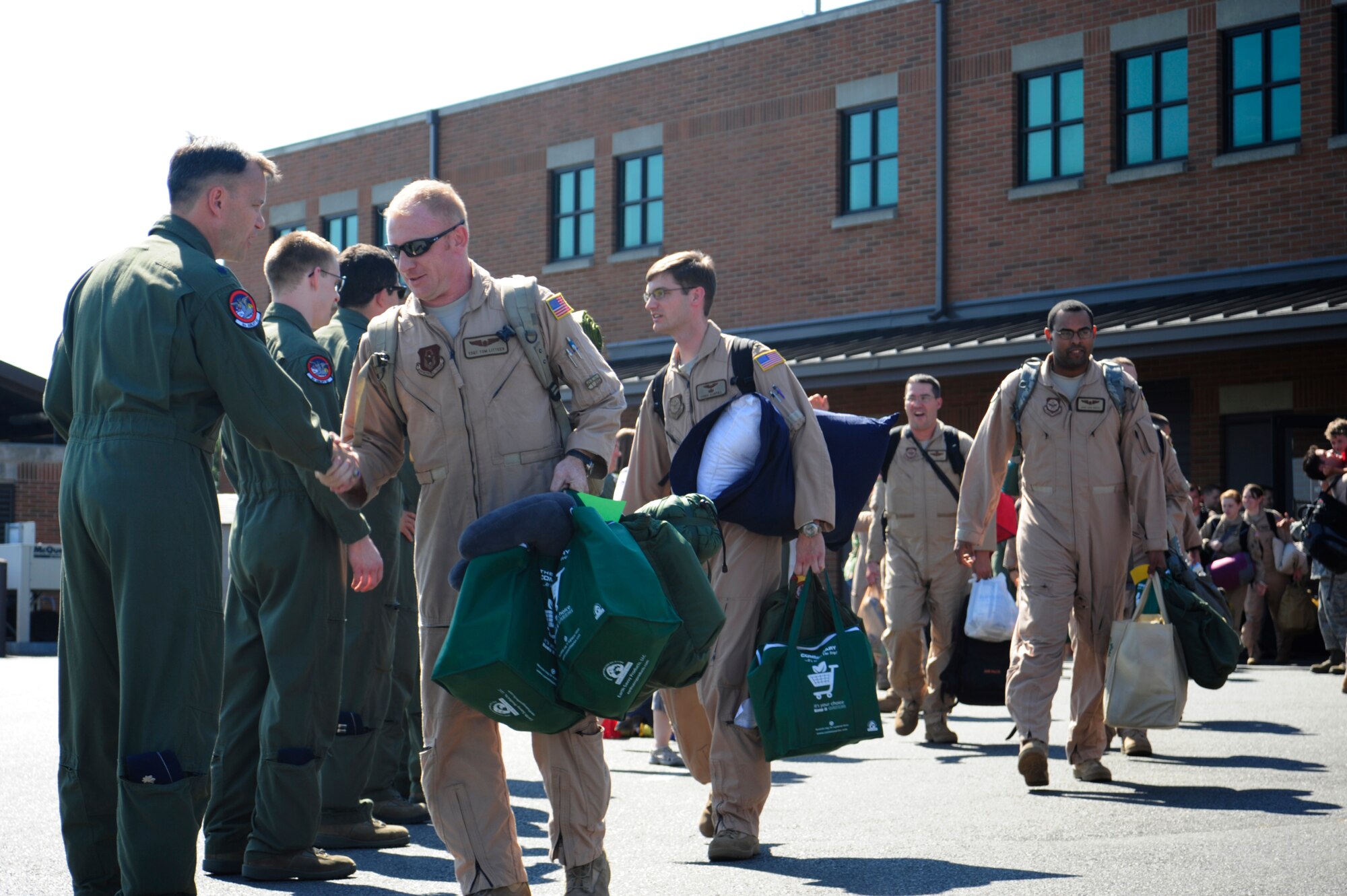 Lt. Col. Thomas O’Connell, 4th Airlift Squadron commander, wishes Airmen good luck as they depart for a 60-day deployment July 25, 2012, at Joint Base Lewis-McChord, Wash. The 4th AS deployed in support of Operations Enduring Freedom, New Dawn, Odyssey Dawn and Combined Joint Task Force-Horn of Africa. (U.S. Air Force photo/Adamarie Lewis-Page)