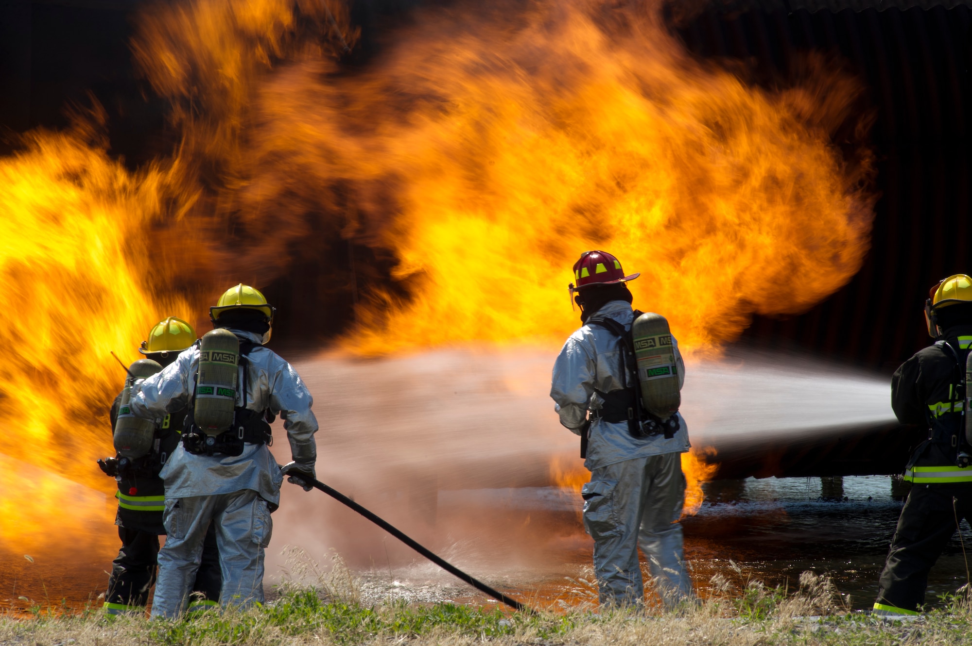 Tech. Sgt. Stephen Pina, 22nd Civil Engineer Squadron firefighter, and fellow Airmen train to fight aircraft fires during an exercise June 8, 2012, McConnell Air Force Base, Kan. Firefighters train to be ready at a moment’s notice and much have above average physical fitness. Pina’s firefighting fitness transferred to his mixed martial arts and help develop his “warrior fitness” lifestyle.  (U.S. Air Force photo/ Airman 1st Class Armando A. Schwier-Morales)