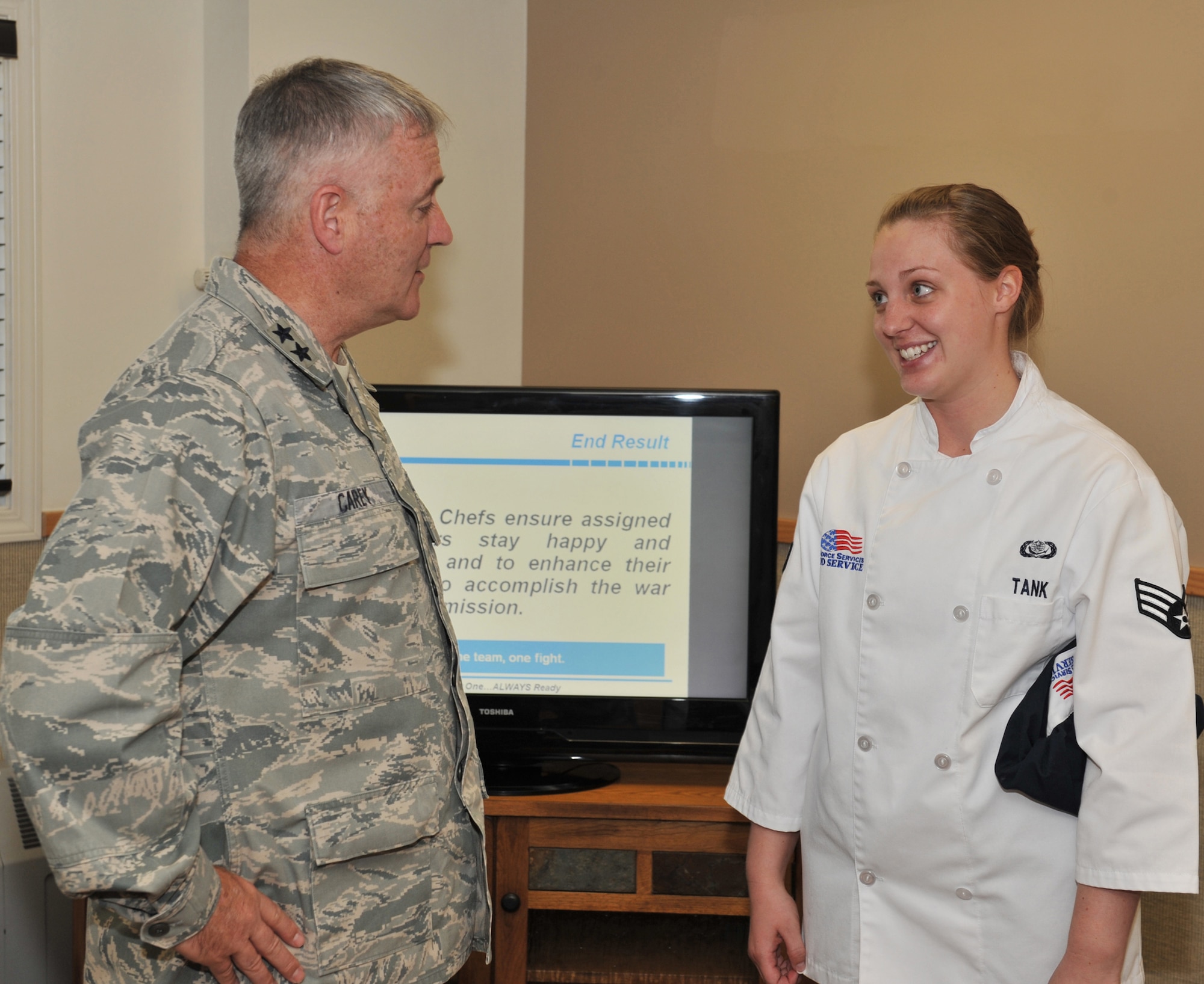 Senior Airman Kara Tank, 10th Missile Squadron chef and Malmstrom's 2011 Airman of the Year, gives a briefing on chef duties and chats with Maj. Gen. Michael Carey, 20th Air Force commander, during his tour to A-01 missile alert facility July 18. She later prepared the general's lunch. (U.S. Air Force photo/John Turner)