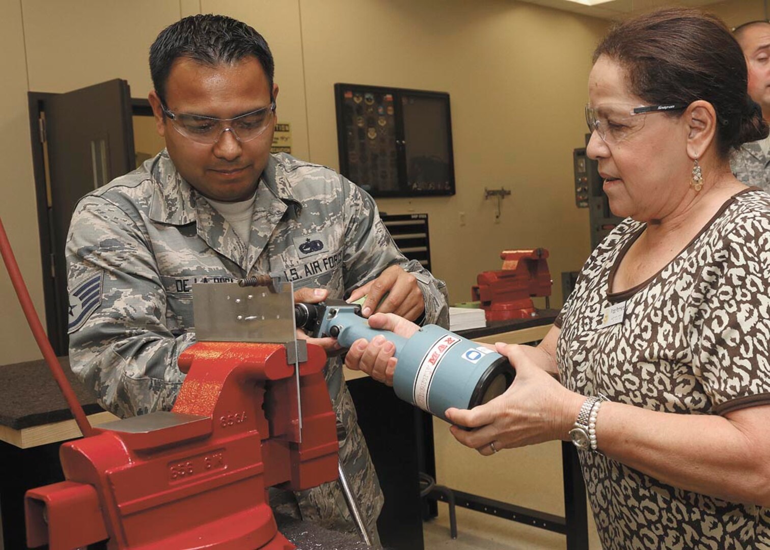 Staff Sgt. Juan De La Rosa describes the different fasteners utilized on aircraft to Ritza Romero, a training manager from Honduras July 17 at Joint Base San Antonio-Lackland. Training managers from 16 Latin American countries attended the Inter-American Air Forces Academy Training Manager Conference. (U.S. Air Force photo/Robbin Cresswell)