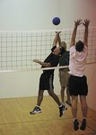 Ruben Martinez and Lance Willoughby, Air Force Intelligence, Surveillance, and Reconnaissance Agency, leap to strike the ball over the net during the inaugural wallyball tournament at the Gillum Fitness Center July 20. (U.S. Air Force photo/Robbin Cresswell)