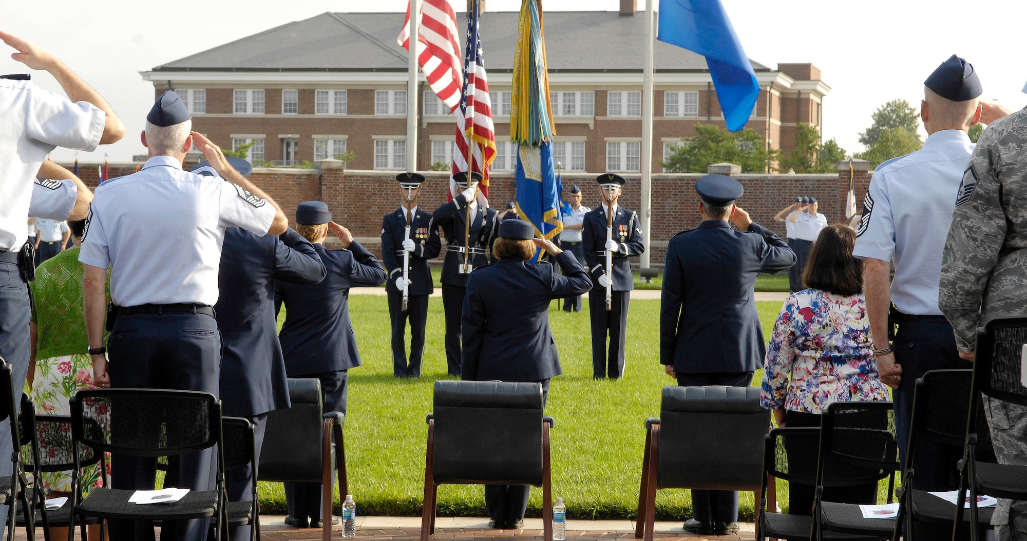 Maj. Gen. Gerard Caron, 79th Medical Wing commander, Col. Roseanne Warner, 579th Medical Group outgoing commander, Col. Kathryn Tate, 579th MDG incoming commander, and those in attendance salute the colors of the U.S. flag during a Change of Command ceremony July 23 on the U.S. Air Force Ceremonial Lawn at Joint Base Anacostia-Bolling, Washington, D.C. (U.S. Air Force photo by Senior Airman Steele C. G. Britton) 