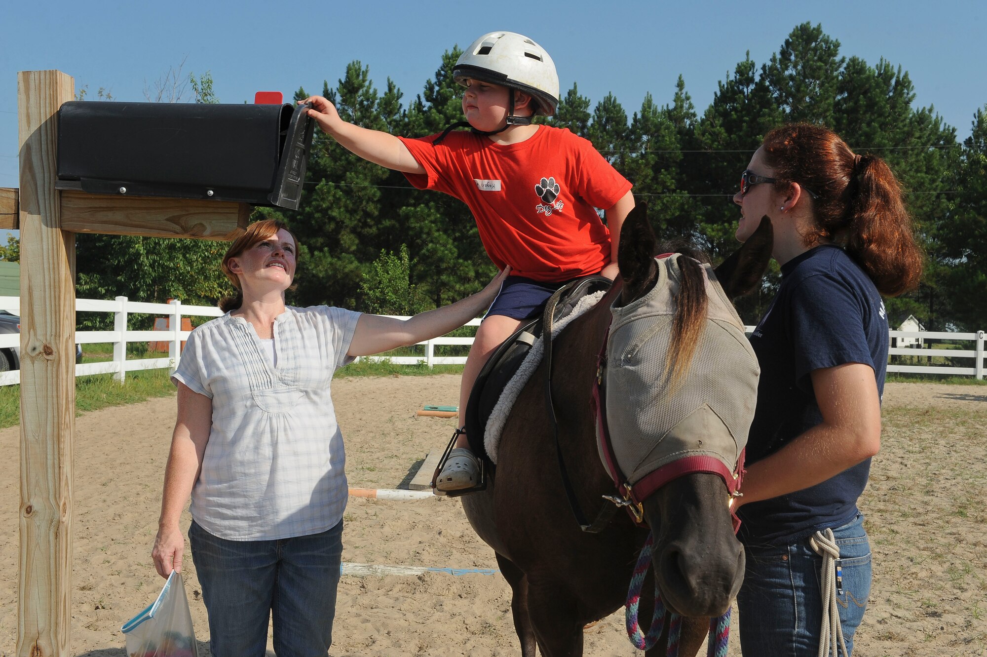 Kegan Smith, son of U.S. Air Force Master Sgt. Rodney Smith, 23d Force Support Squadron, checks a mailbox for a prize at Jacobs’ Ladder Therapeutic Riding Center, Hahira, Ga., July 25, 2012. This is the first year Jacobs’ Ladder  partnered with the Exceptional Family Members Program to provide a summer camp for Moody Air Force Base, Ga., families. They first worked together in April 2011 during the Month of the Military Child. (U.S Air Force photo by Staff Sgt. Ciara Wymbs/Released)