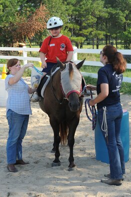 Kegan Smith, son of U.S. Air Force Master Sgt. Rodney Smith, 23d Force Support Squadron, rides a horse at Jacobs’ Ladder Therapeutic Riding Center, Hahira, Ga., July 25, 2012. Jacobs’ Ladder provides equine related activities to individuals with special needs. (U.S. Air Force photo by Staff Sgt. Ciara Wymbs/Released) 