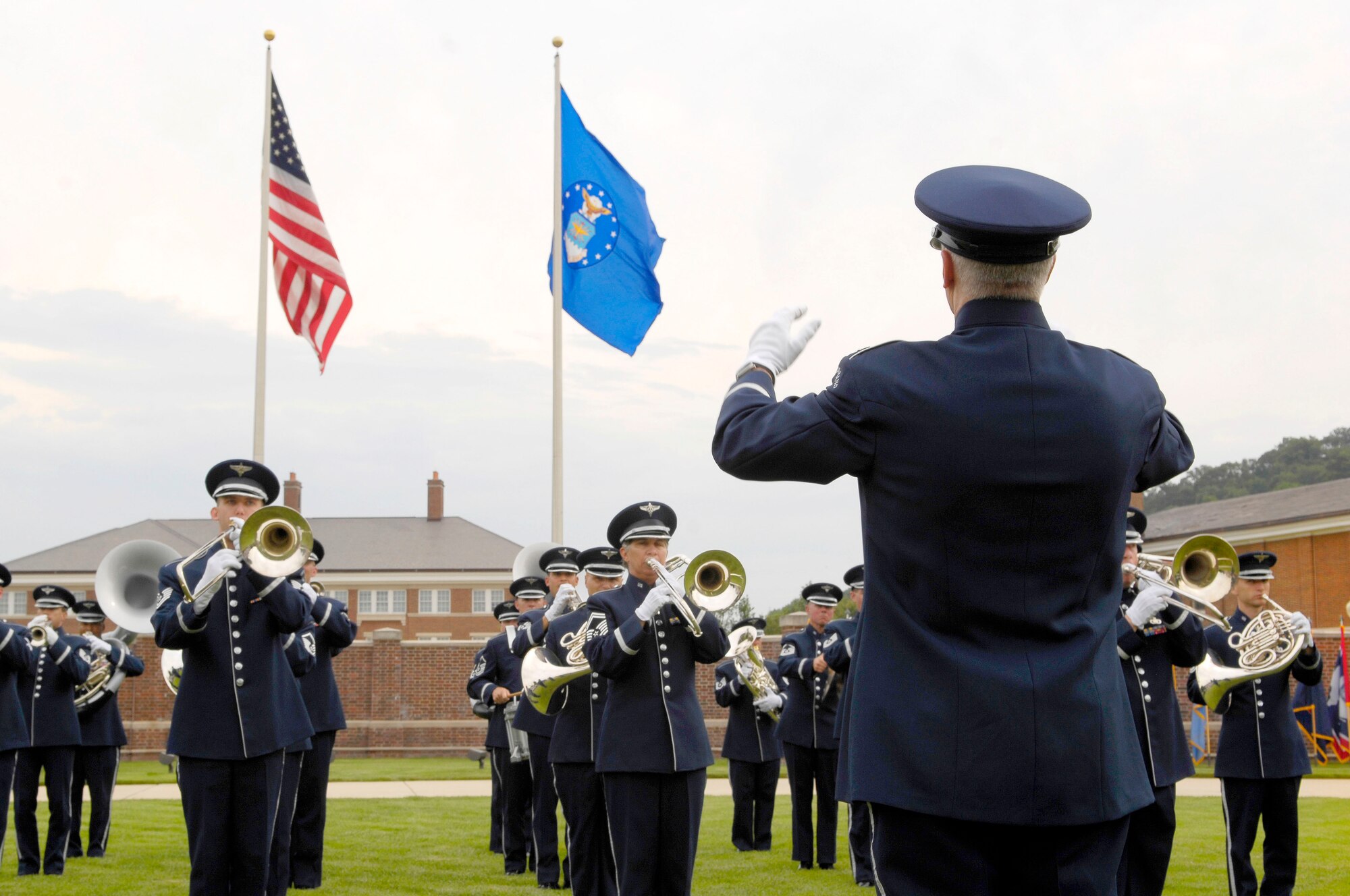 U.S. Air Force Band Commander Col. Larry Lang conducts ceremonial band performers during the Air Force District of Washington change of command ceremony on the U.S. Air Force Ceremonial Lawn July 26 at Joint Base Anacostia-Bolling, Washington, D.C. During the ceremony, Maj. Gen. Sharon K.G. Dunbar assumed command from outgoing commander Maj. Gen. Darren W. McDew. (U.S. Air Force photo by Senior Airman Steele C. G. Britton)