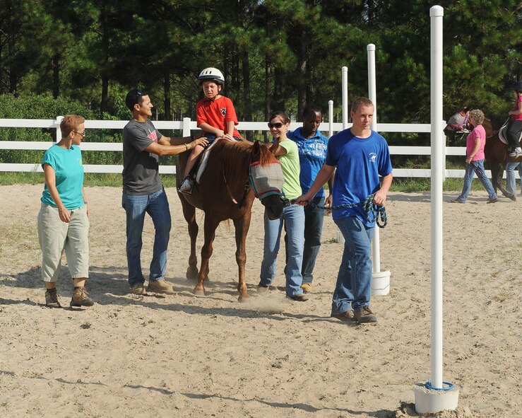 Jory Smith, son of U.S. Air Force Master Sgt. Rodney Smith, 23d Force Support Squadron, rides a horse at Jacobs’ Ladder Therapeutic Center, Hahira, Ga., July 25, 2012. The children participated in horseback riding and other horse-related activities, arts and crafts, and other games throughout the day. (U.S. Air Force photo by Staff Sgt. Ciara Wymbs/Released)