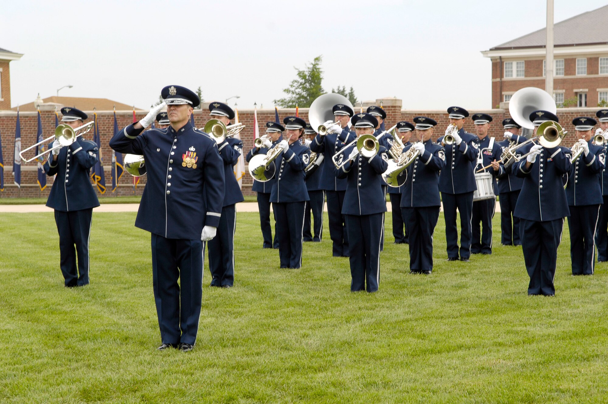 U.S. Air Force Band Commander Col. Larry Lang salutes while the U.S. Air Force Band performs during the Air Force District of Washington change of command ceremony on the U.S. Air Force Ceremonial Lawn July 26 at Joint Base Anacostia-Bolling, Washington, D.C. During the ceremony, Maj. Gen. Sharon K.G. Dunbar assumed command from outgoing commander Maj. Gen. Darren W. McDew. (U.S. Air Force photo by Senior Airman Steele C. G. Britton)