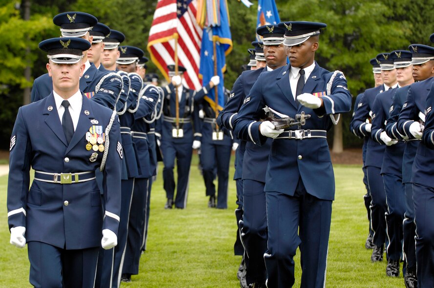 The U.S. Air Force Honor Guard performs a pass in review during the Air Force District of Washington change of command on the U.S. Air Force Ceremonial Lawn July 26 at Joint Base Anacostia-Bolling, Washington, D.C. During the ceremony, Maj. Gen. Sharon K.G. Dunbar assumed command from outgoing commander Maj. Gen. Darren W. McDew. (U.S. Air Force photo by Senior Airman Steele C. G. Britton)