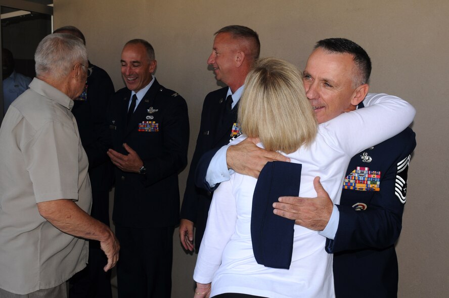 Air National Guard Chief Master Sgt. Mark McDaniel, 173rd Fighter Wing Logistics Readiness Squadron, shares a hug with his wife after his chief pinning ceremony at Kingsley Field, Ore., July 25, 2012. Three members from Kingsley Field put on the rank of Chief Master Sergeant during the ceremony. (Air National Guard photo by Airman 1st Class Penny Hamilton/Released)