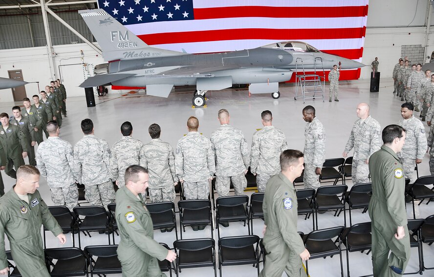 Pilots and crew chiefs file in during  a Dedicated Crew Chief ceremony  at Homestead Air Reserve Base, July 15. The ceremony formally appointed and reaffirmed 26 technicians assigned to oversee the maintenance and safety of their designated aircraft.  (U.S. Air Force photo/ Staff Sgt. Lou Burton, 482nd Fighter Wing Public Affairs.)