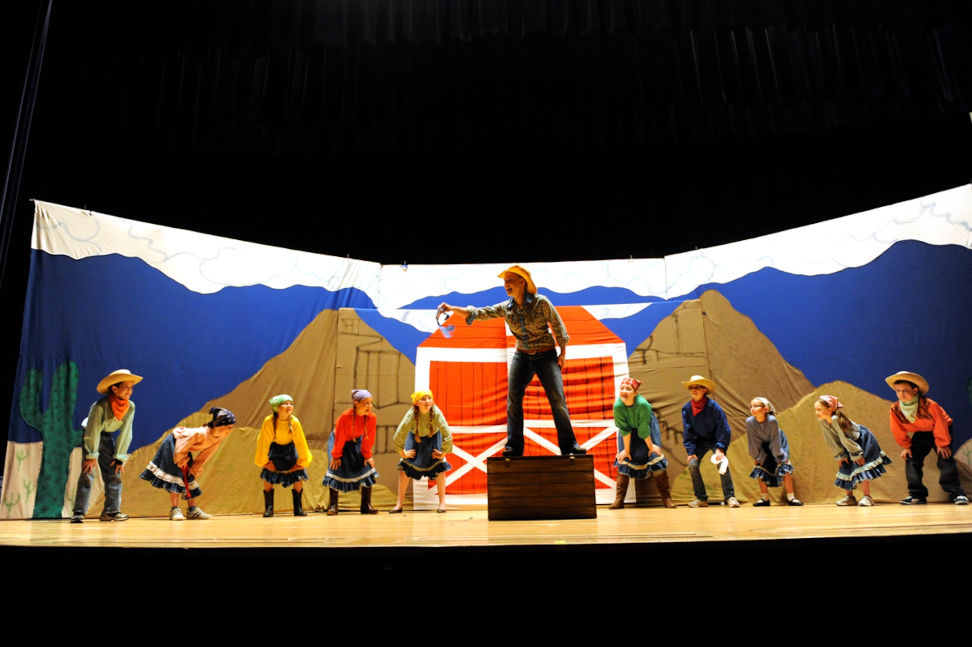 Children working with members of the Missoula Children's Theatre perform on stage during a "Beauty Lou and the Country Beast" rehearsal at the Elmendorf-side theater on Joint Base Elmendorf-Richardson, Alaska July 20. The show was arranged and put on by the Missoula Children's Theatre and also provided shows on July 13 on the Fort Richardson side. The theatre provides performances including comical twists on original fairy tales and other popular stories. (U.S. Air Force photo/Staff Sgt. Robert Barnett)