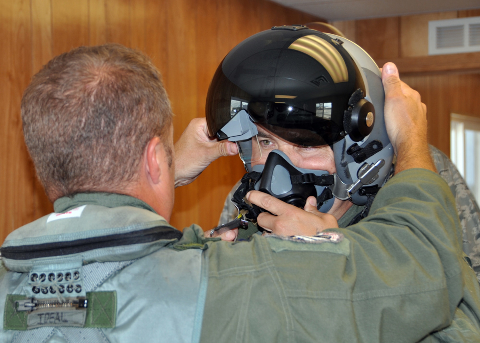 JOINT BASE PEARL HARBOR-HICKAM, Hawaii - U.S. Air Force Lt. Col. Tom McNurlin from the Air National Guard and Air Force Reserve Test Center in Tucson, Ariz., helps U.S. Air Force Col. John Breazeale, 917th Fighter Group commander, adjust his helmet with the Scorpion helmet-mounted system prior to a flight during Rim of the Pacific exercise July 17,2012.  The Scorpion system, along with the Lightweight Airborne Recovery System, known as LARS, was for the first time maritime operationally tested during the exercise. The world's largest international maritime exercise, RIMPAC provides a unique training opportunity that helps participants foster and sustain the cooperative relationships that are critical to ensuring the safety of sea lanes and security on the world's oceans. (U.S. Air Force photo by Master Sgt. Mary Hinson)