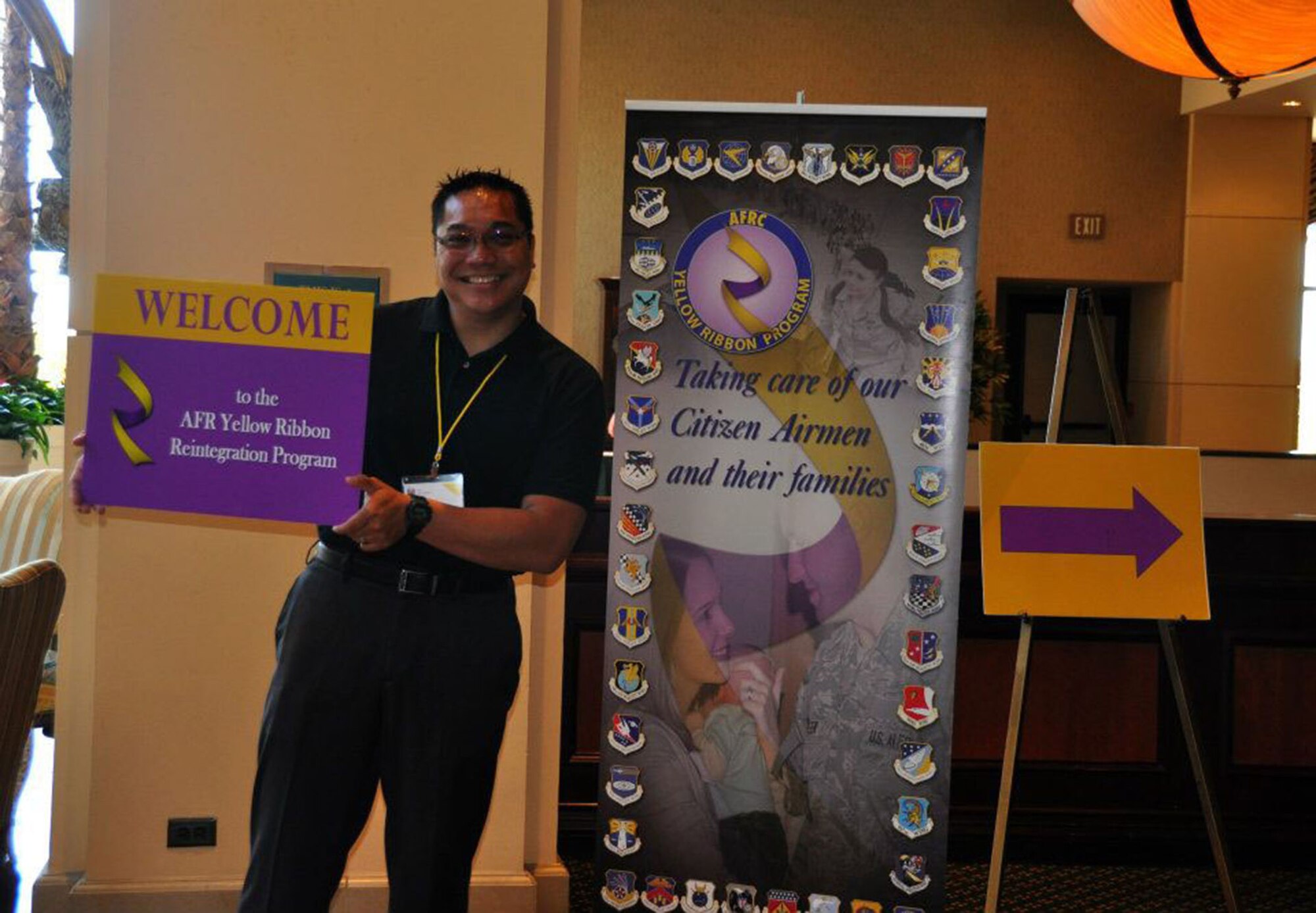 TRAVIS AIR FORCE BASE, Calif. -- Master Sgt. Emil Canlas, 349th Logistics Readiness Squadron, shows support to his fellow Air Force Reservists at the Yellow Ribbon event held in San Diego, by volunteering to direct them to the appropriate area on July 20, 2012. (U.S. AIR FORCE PHOTO/ Senior Airman Amelia Leonard)