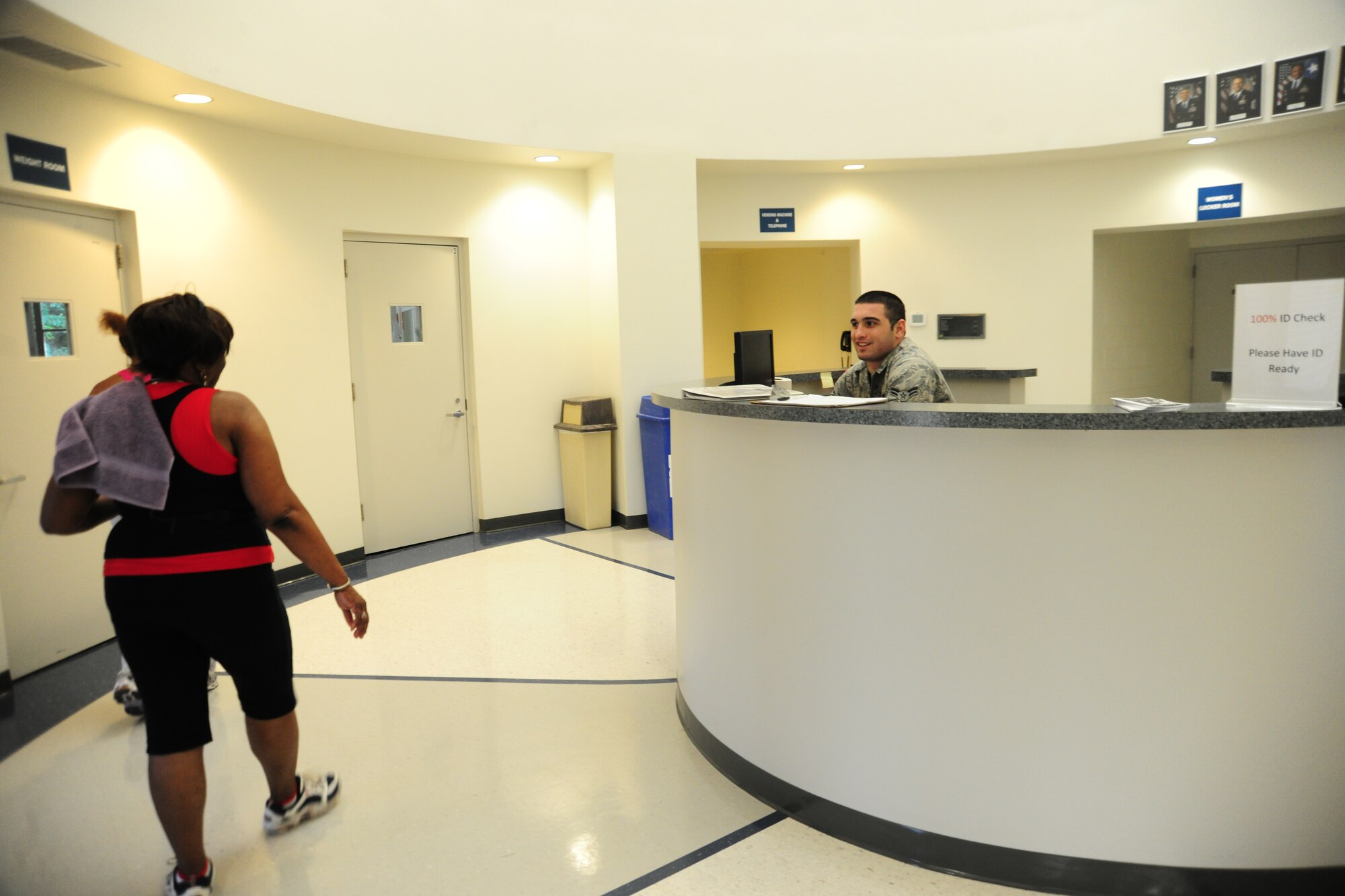 Airman 1st Class Joey Carfagno, 11th Logistics Readiness Squadron logistics planner, greets East Fitness Center patrons as they arrive at the newly-renovated East Fitness Center on July 25, 2012.  The EFC is open Monday – Friday, from 6am to 6pm. (U.S. Air Force Photo/Senior Airman Amber Russell)