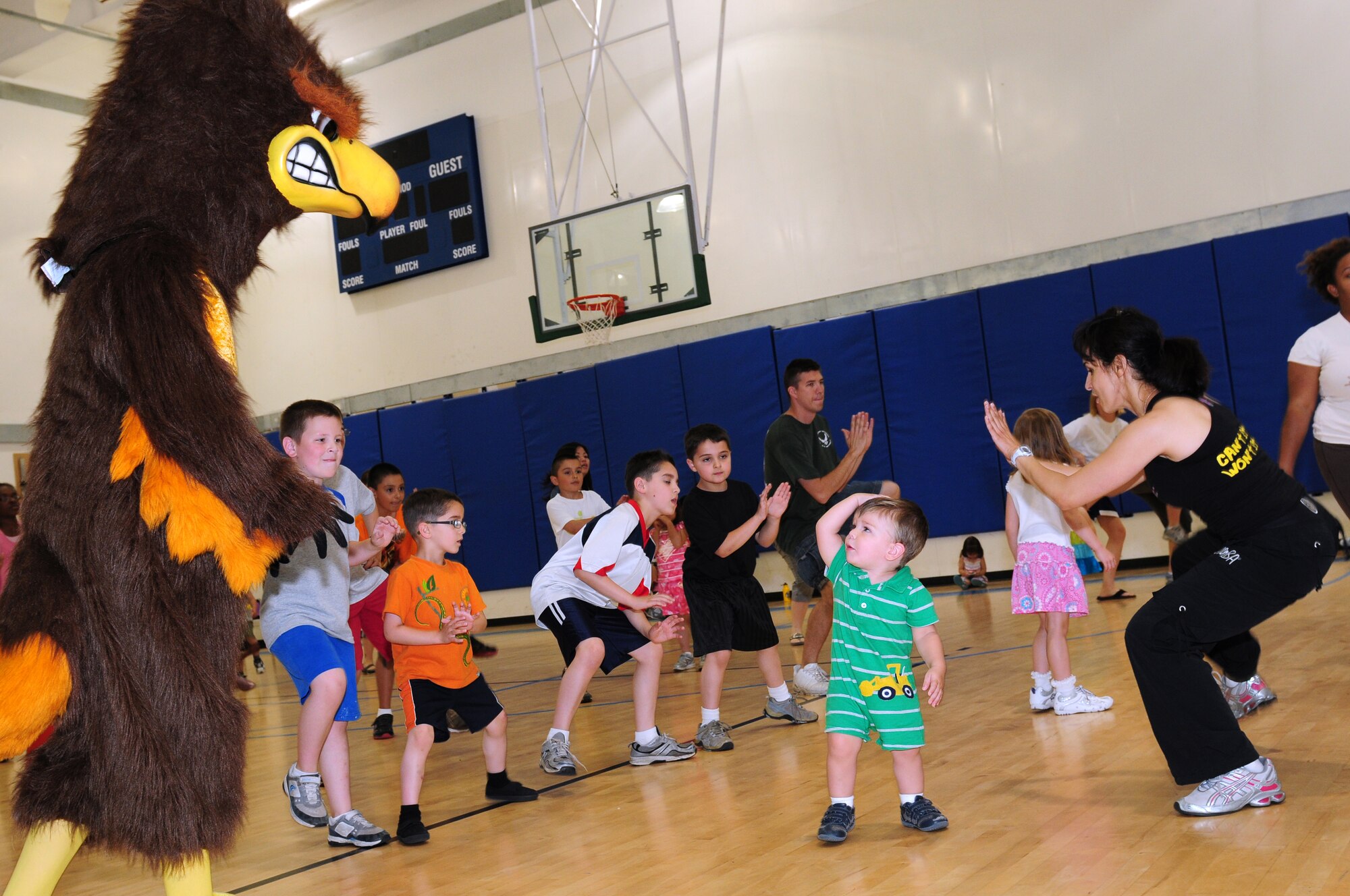ROYAL AIR FORCE LAKENHEATH, England –The 48th Medical Group Health and Wellness Center Hawk joins a group of children and adults participating in a Zumba class during a food play-date July 25, 2012. The 48th Medical Group Health and Wellness Center hosted the food play-date all week promoting healthy living to children through nutritional activities and fun exercises. (U.S. Air Force photo by Airman 1st Class Cory D. Payne)