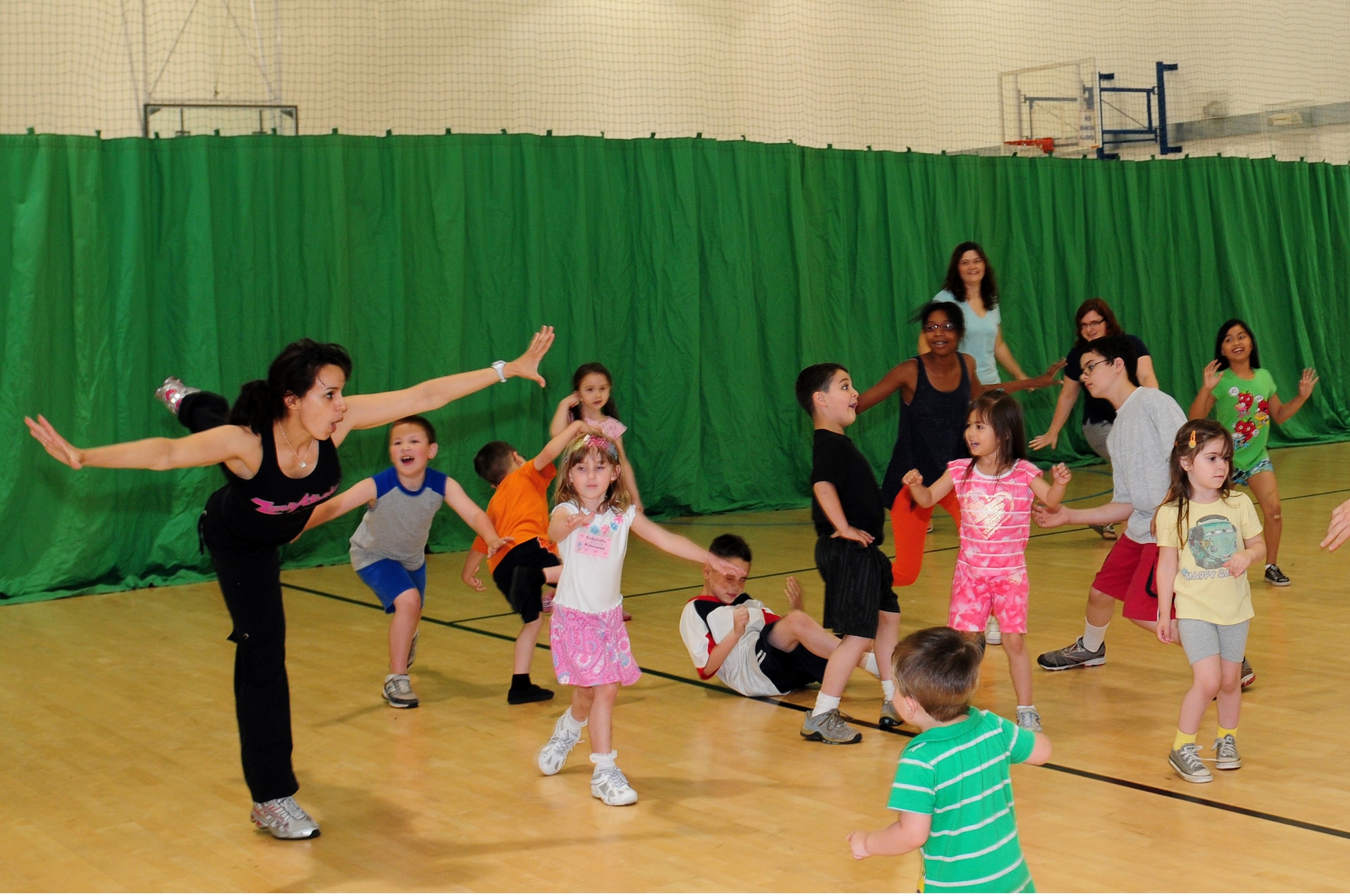 ROYAL AIR FORCE LAKENHEATH, England – Fathia Clay, 48th Medical Group Health and Wellness Center instructor, leads a class of children and adults in a Zumba exercise during a food play-date July 25, 2012. The HAWC hosted the food play-date all week promoting healthy living to children through nutritional activities and fun exercises. (U.S. Air Force photo by Airman 1st Class Cory D. Payne)
