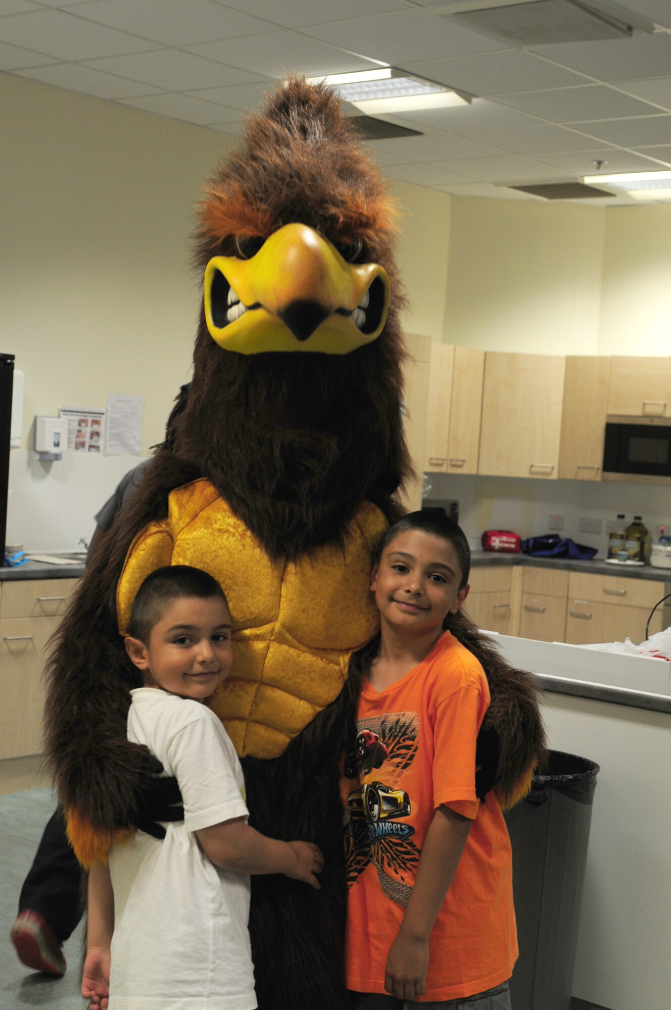 ROYAL AIR FORCE LAKENHEATH, England – The 48th Medical Group Health and Wellness Center Hawk poses with Daniel (left), 7, and Isaac Garcia, 9, during a food play-date July 25, 2012. The HAWC hosted the food play-date all week promoting healthy living to children through nutritional activities and fun exercises. (U.S. Air Force photo by Airman 1st Class Cory D. Payne)