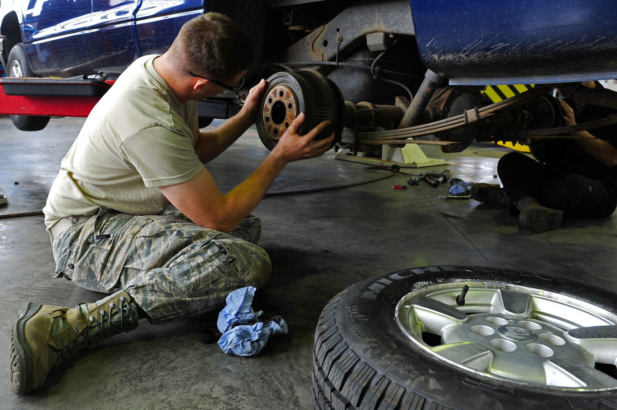 Airman 1st Class John Clark, 86th Vehicle Readiness Squadron vehicular maintenance mechanic, clean and adjusts drum breaks on a government vehicle at the 86th VRS general purpose light shop on Ramstein Air Base, Germany, July 12, 2012. The 43 members of GP Light work hard year-round to provide premier full-service vehicle operations and management support to members of Team Ramstein and associate units across Europe and Africa. (U.S. Air Force photo/Airman 1st Class Holly Cook)