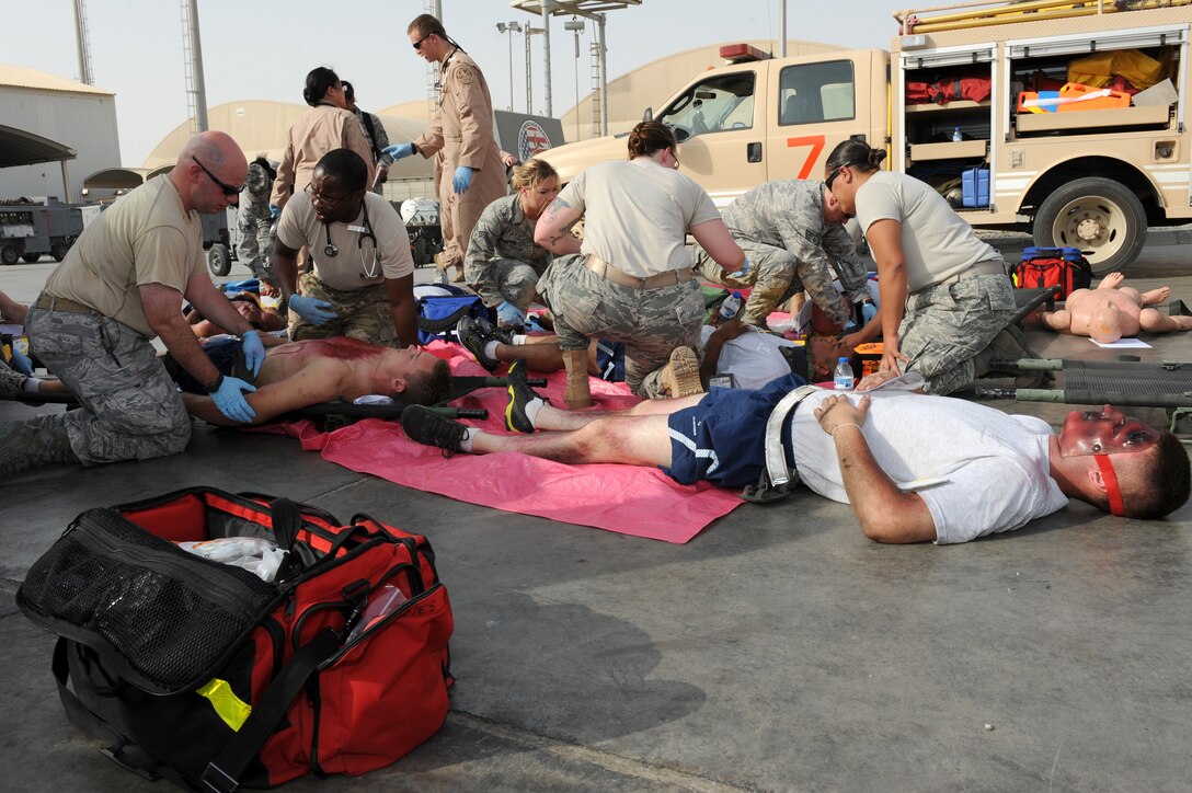 SOUTHWEST ASIA - Members of the 380th Expeditionary Medical Group provide aid to the wounded during a major accident response exercise at the 380th Air Expeditionary Wing July 25, 2012. The exercise tested the wing's ability to respond to a major accident. (U.S. Air Force photo/Master Sgt. Scott MacKay)