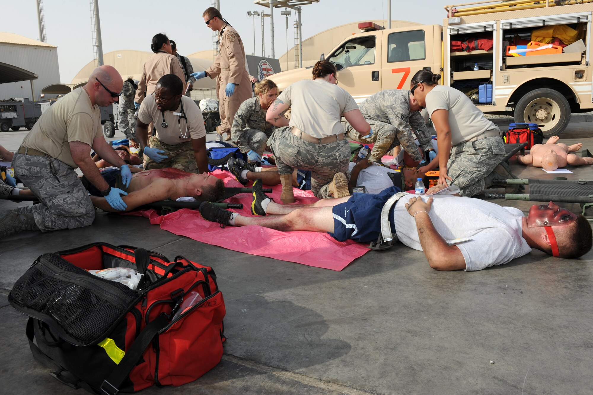SOUTHWEST ASIA - Members of the 380th Expeditionary Medical Group provide aid to the wounded during a major accident response exercise at the 380th Air Expeditionary Wing July 25, 2012. The exercise tested the wing's ability to respond to a major accident. (U.S. Air Force photo/Master Sgt. Scott MacKay)